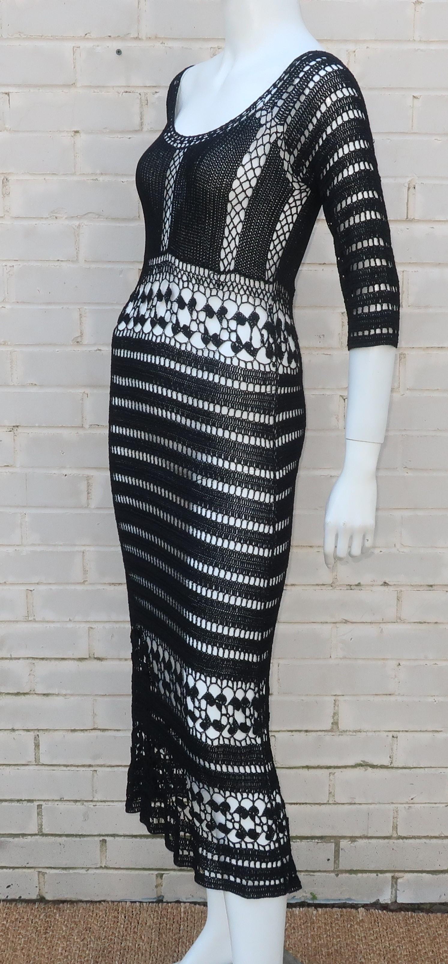 A 1990's black crochet dress designed by Allen Schwartz for his ABS label with a definitive nod to the bohemian looks of the early 1970's.  The pullover dress drapes the body beautifully with an intricate design in heavy cording that scoops at the