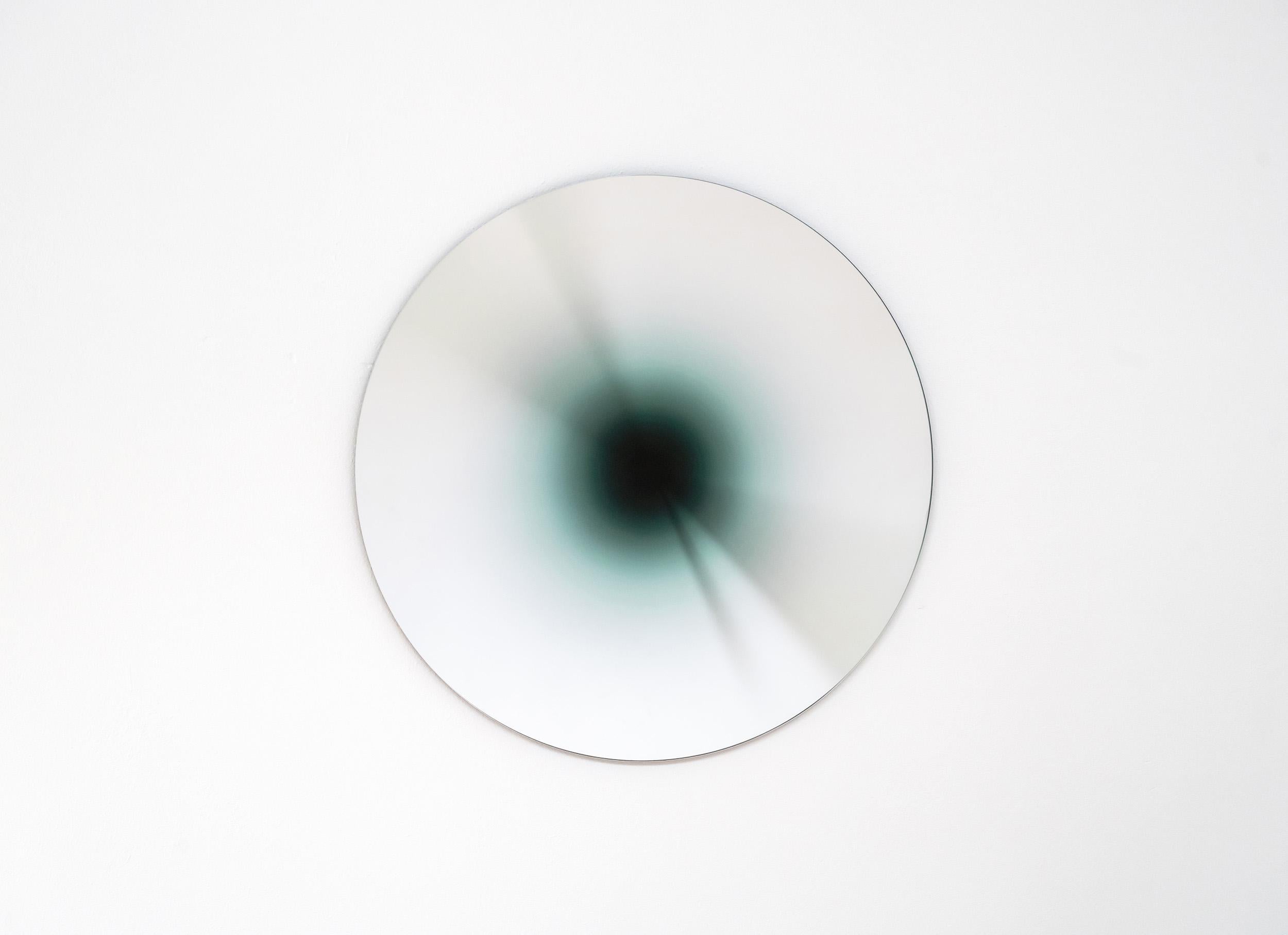 Absence is part of a limited series of glass mirrors resulting from the exploration of the absence of light. 

Its 'black-hole’ effect is created by concentric coloured gradients radiating from the centre, giving a sense of depth and endlessness.