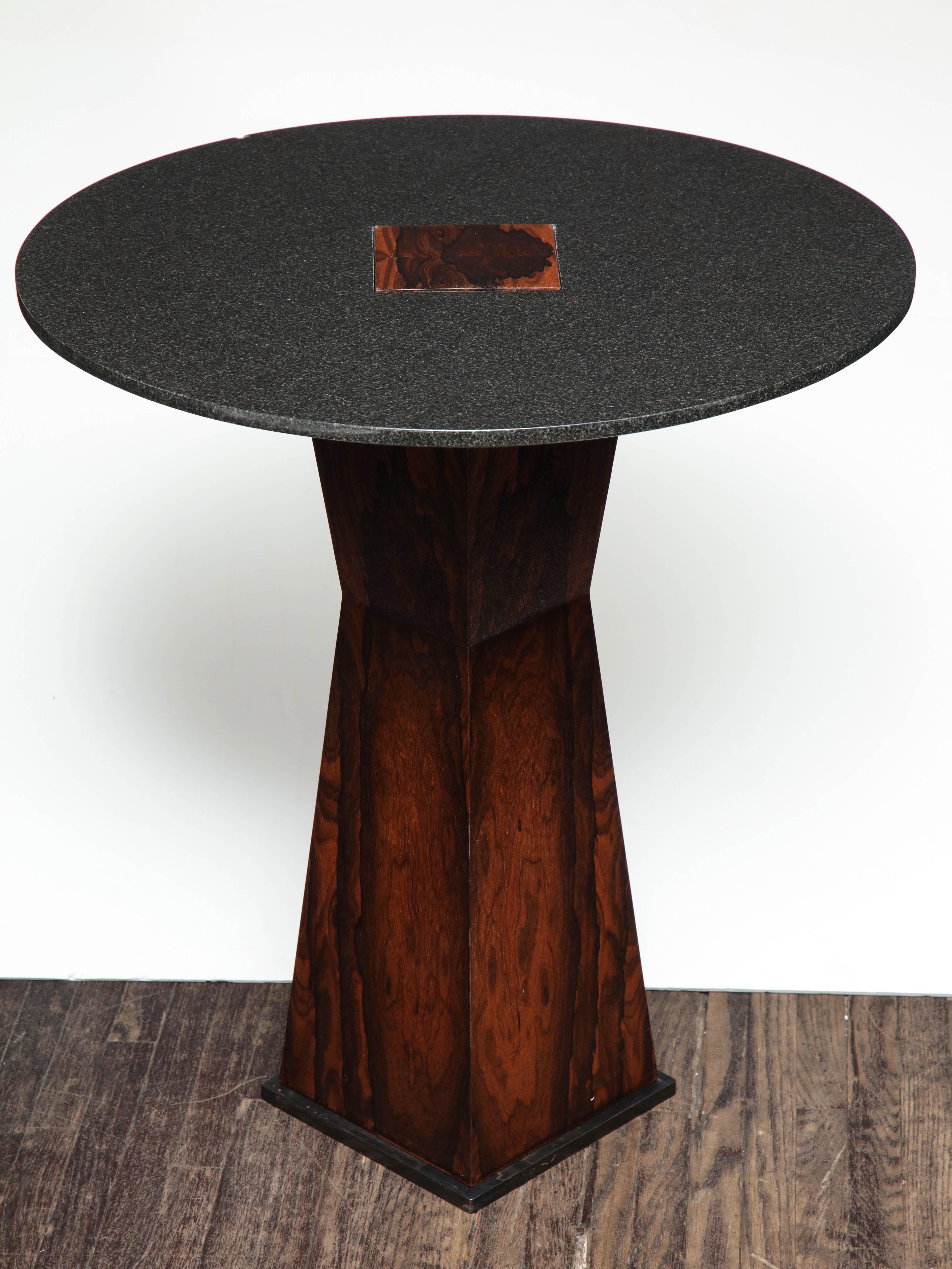 Absolute black granite side table with patinated steel.
Base: Sculptural base made of French polished Ziricote wood.