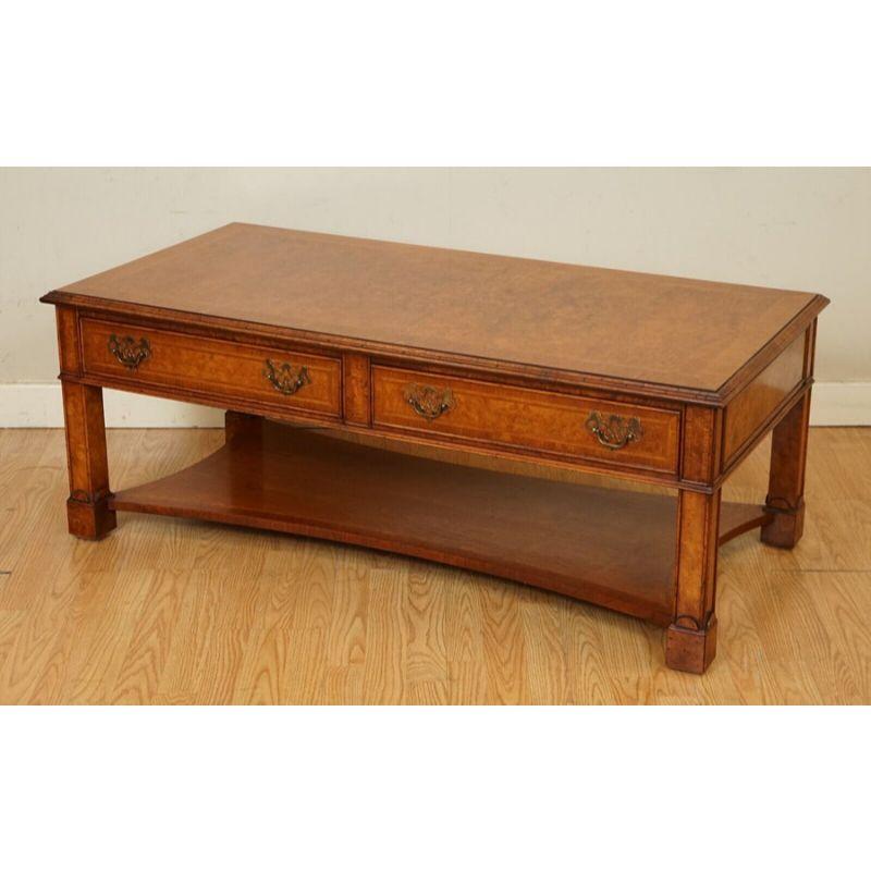 We are delighted to offer for sale this Beautiful brights of nettlebed coffee table.

A very well-made table in mint condition. It has stunning burrs all over and includes two drawers on one side, and on the other side are dummy drawers.

We