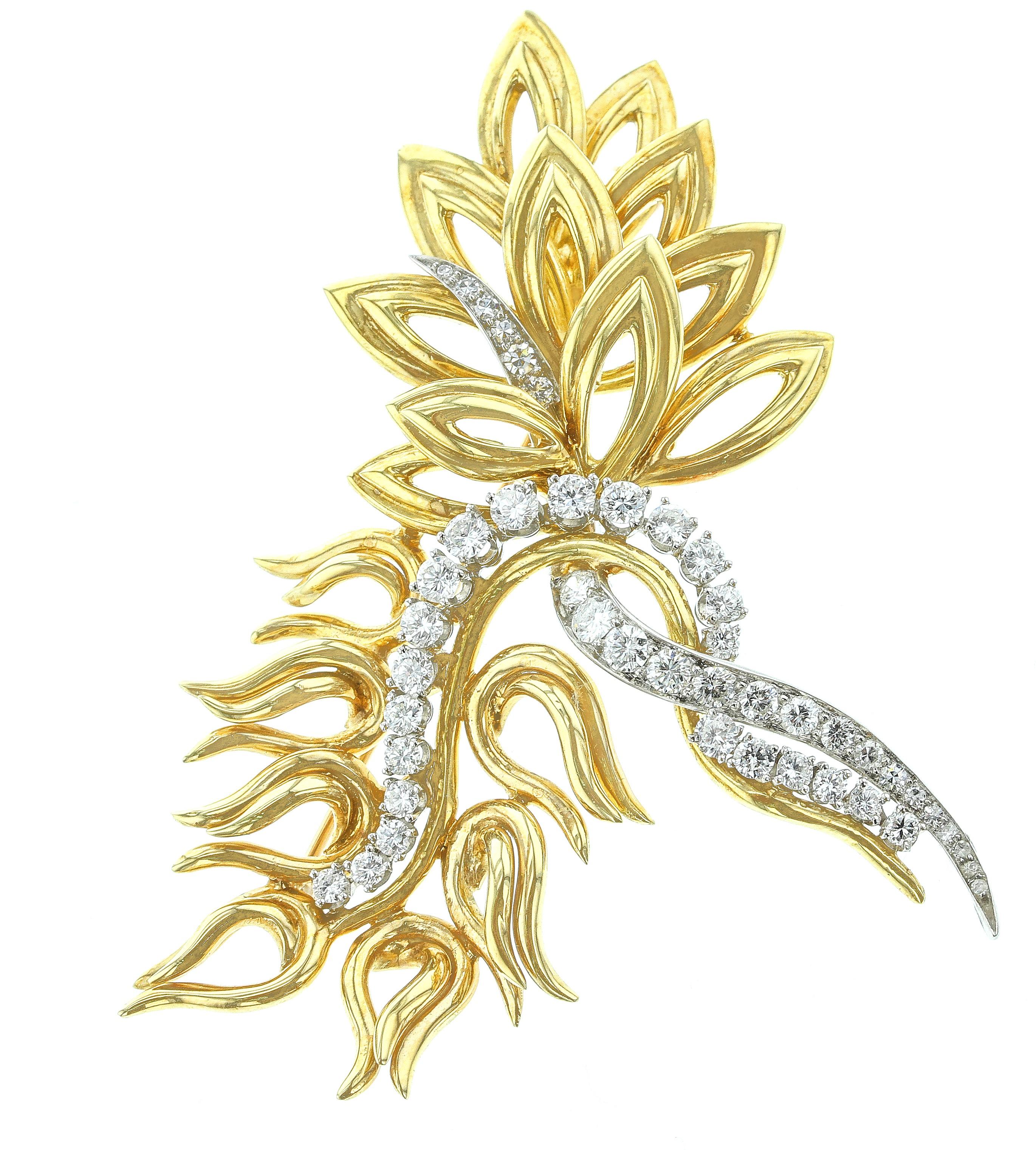 An abstract pin in 18K Yellow Gold and Platinum, set with Diamonds. Circa 1960, Retailed by Harry Winston. Length: 2