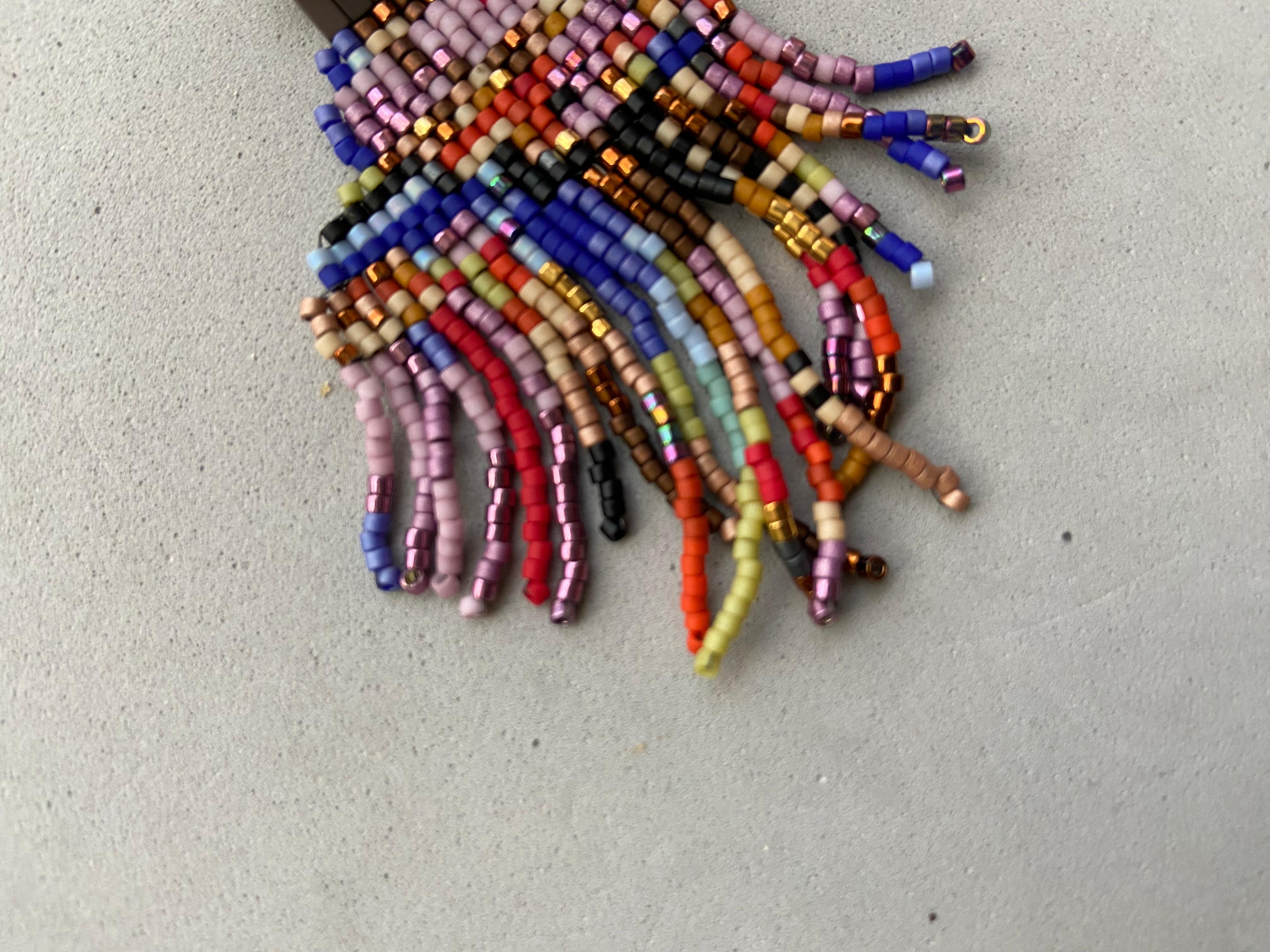 These earrings have the lines and look of a fine art painting.  They are inspired by artists like Jean-Michel Basquiat or Wassily and their contemporary abstract aesthetic.  The pair are hand beaded with colorful glass beads and hematite gemstone. 