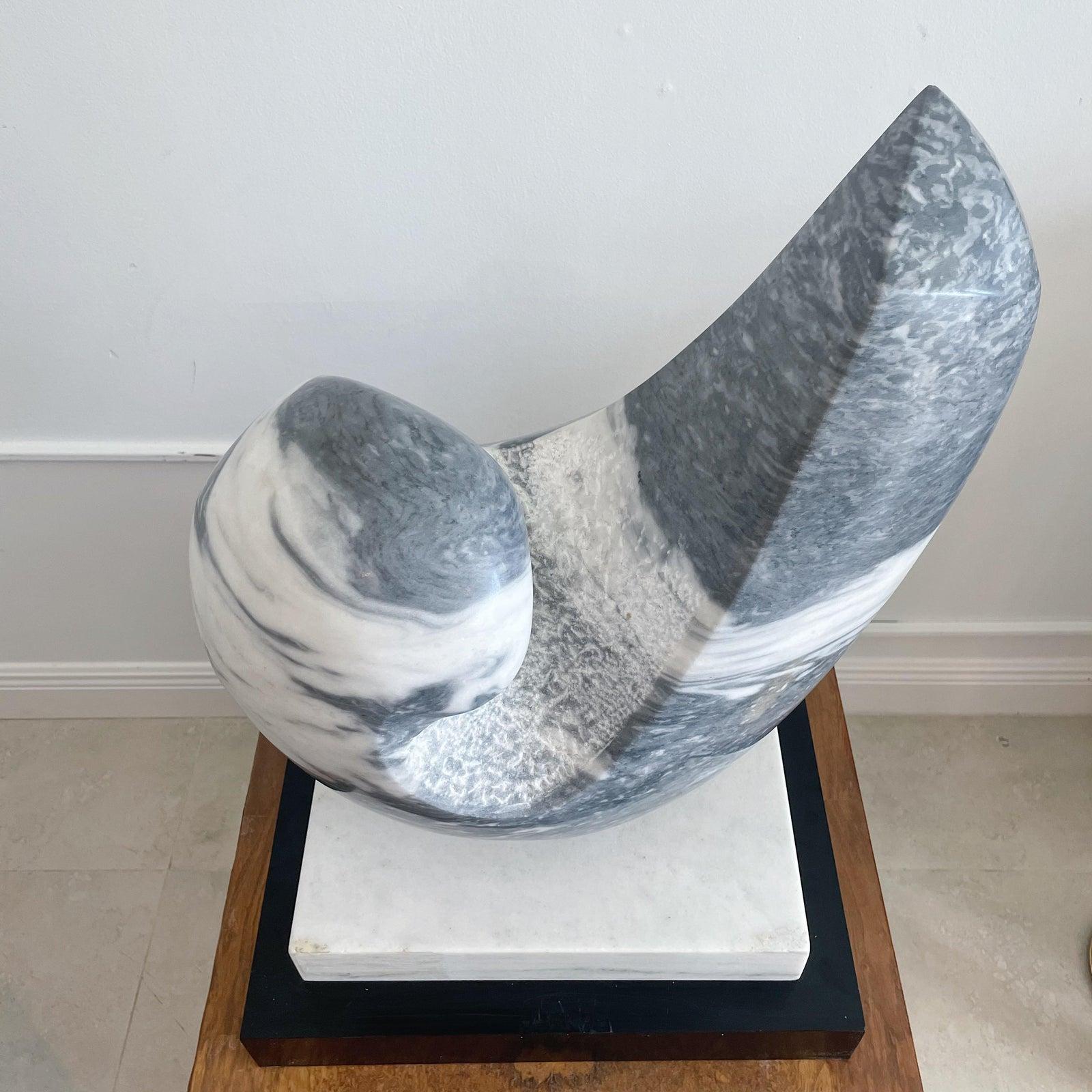 Hand carved large freeform abstract sculpture in white and grey hues. On black wood laminate covered base. Extremely heavy. Unsigned.