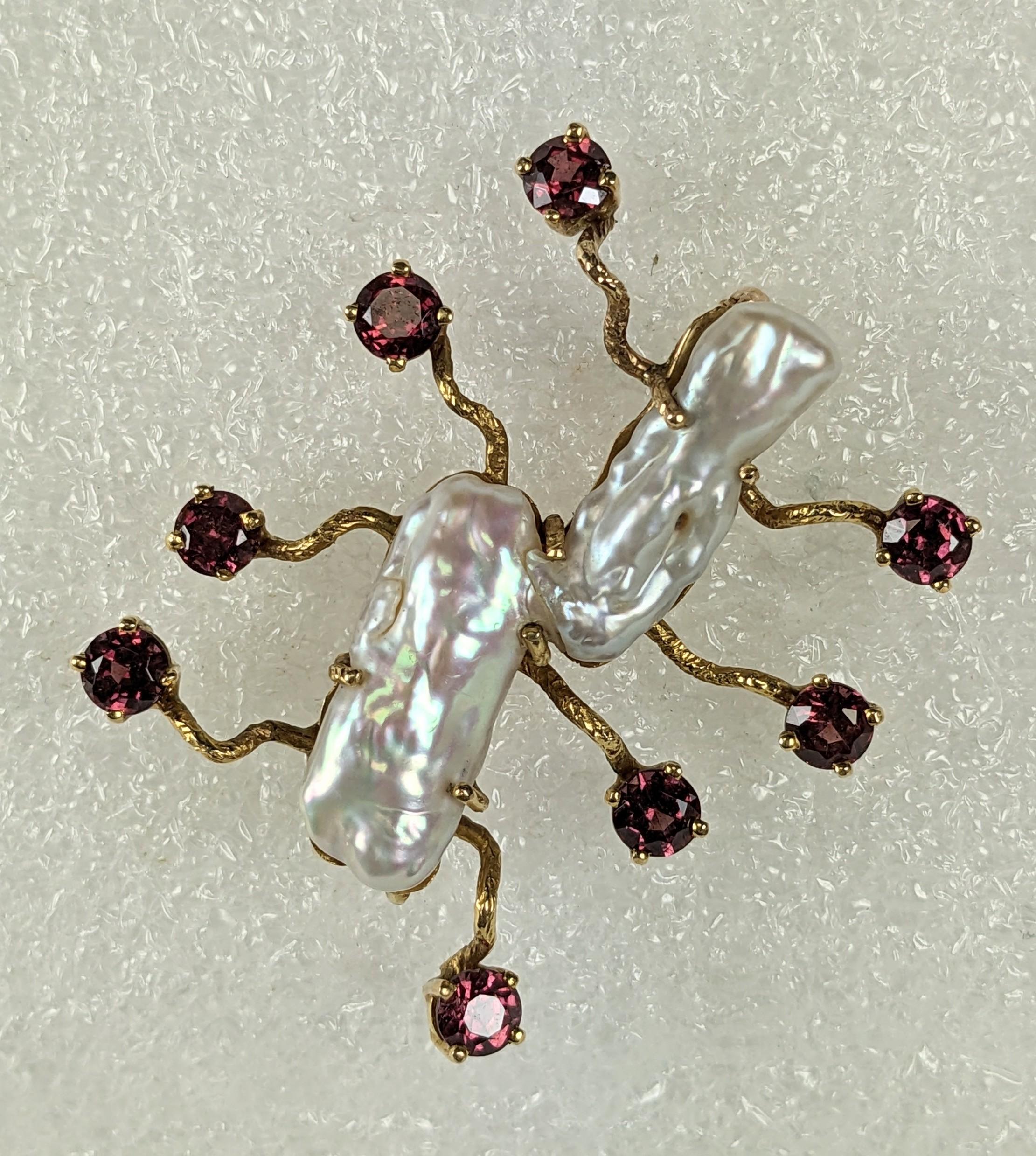 Charming, Abstract Biwa Pearl Centipede Brooch set in 14k gold with garnet set feet. Abstract design which can be worn in many directions.  
1.5