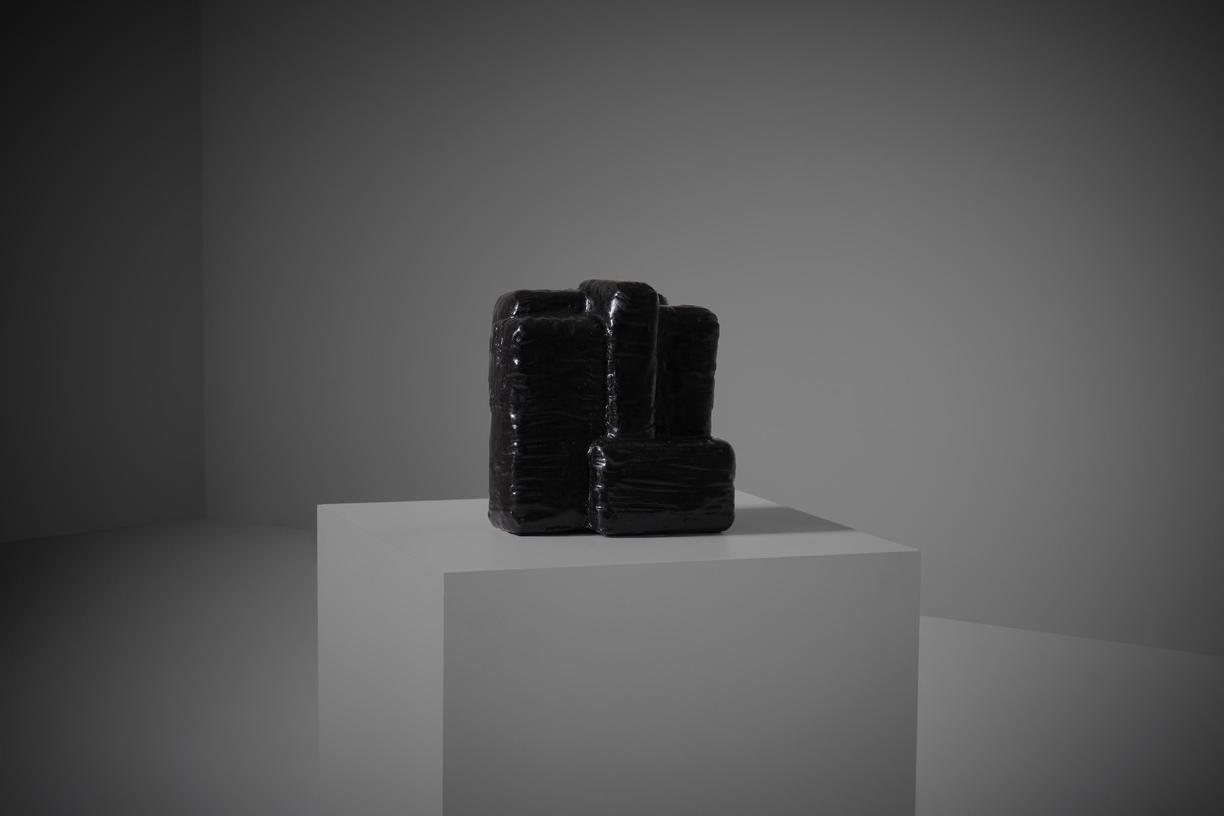 Abstract cubistic ceramic sculpture, The Netherlands 1970s. The sculpture is made out of heavy chamotte clay with a beautiful black glazed finish. Interesting composition out of several interlocking communicating cubic shapes with an outspoken and