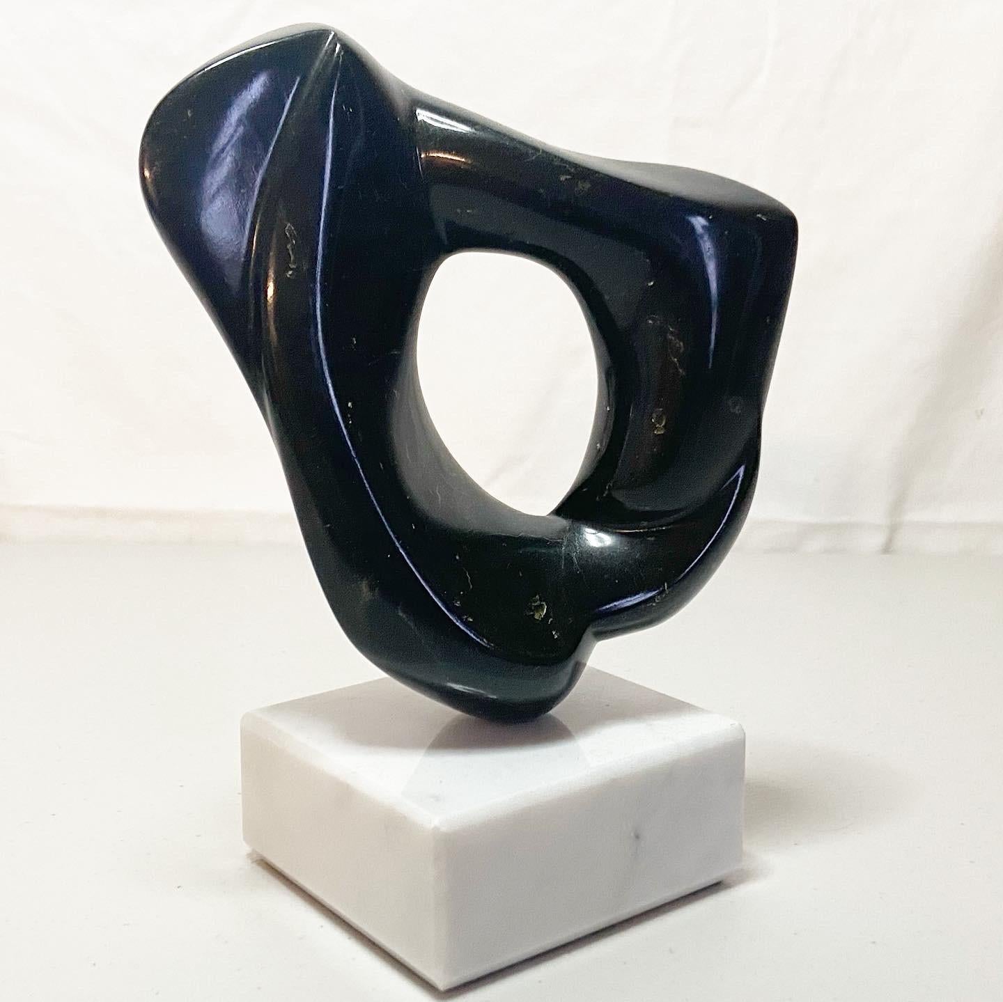 Beautiful abstract sculpture in polished black marble with a white marble base.
 