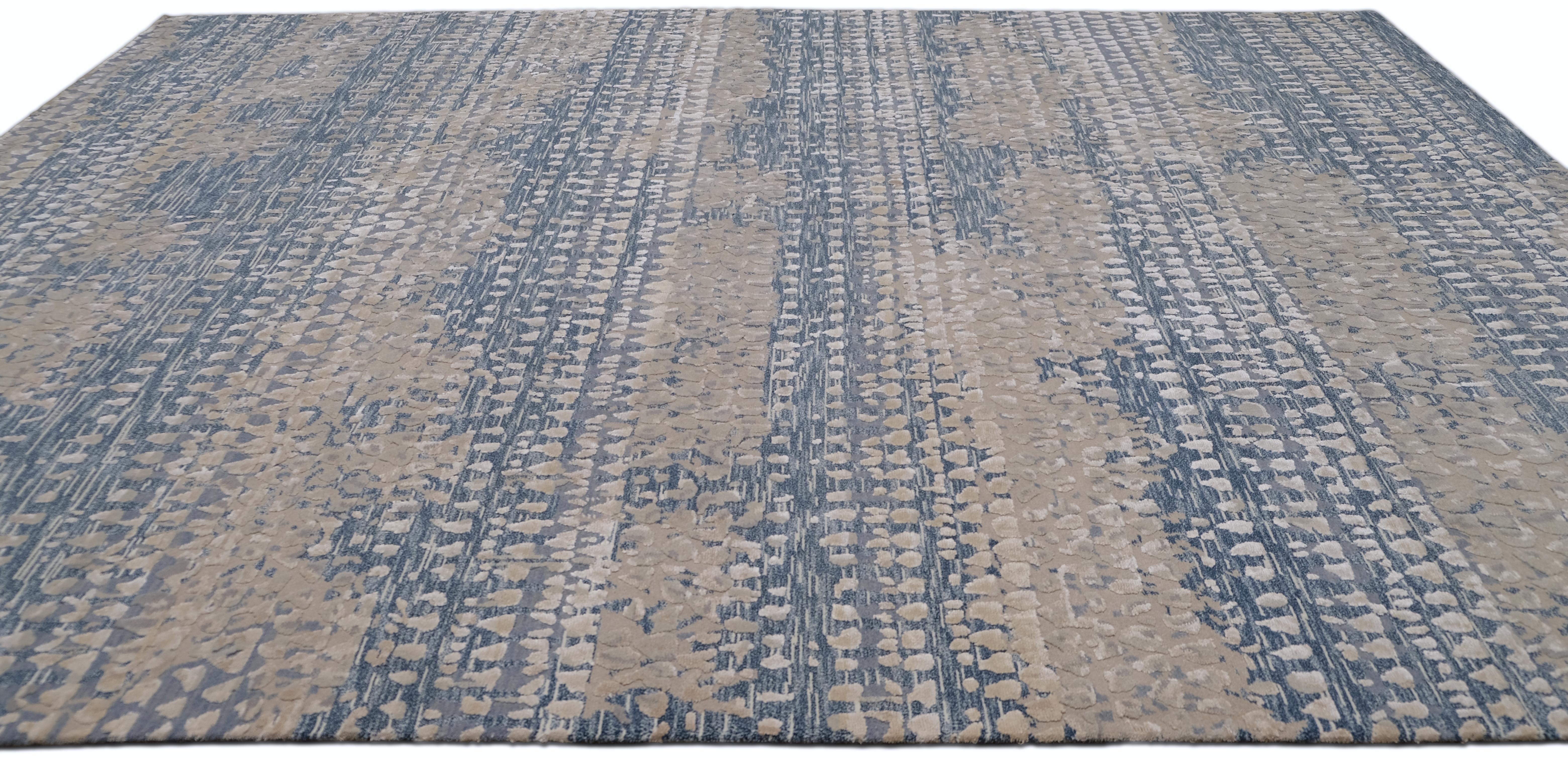 Elevate your interior with this luxurious hand-knotted wool and silk rug, featuring an artistic abstract pattern in soft blue and beige tones. The intricate texture and contemporary design create a harmonious balance between modern elegance and