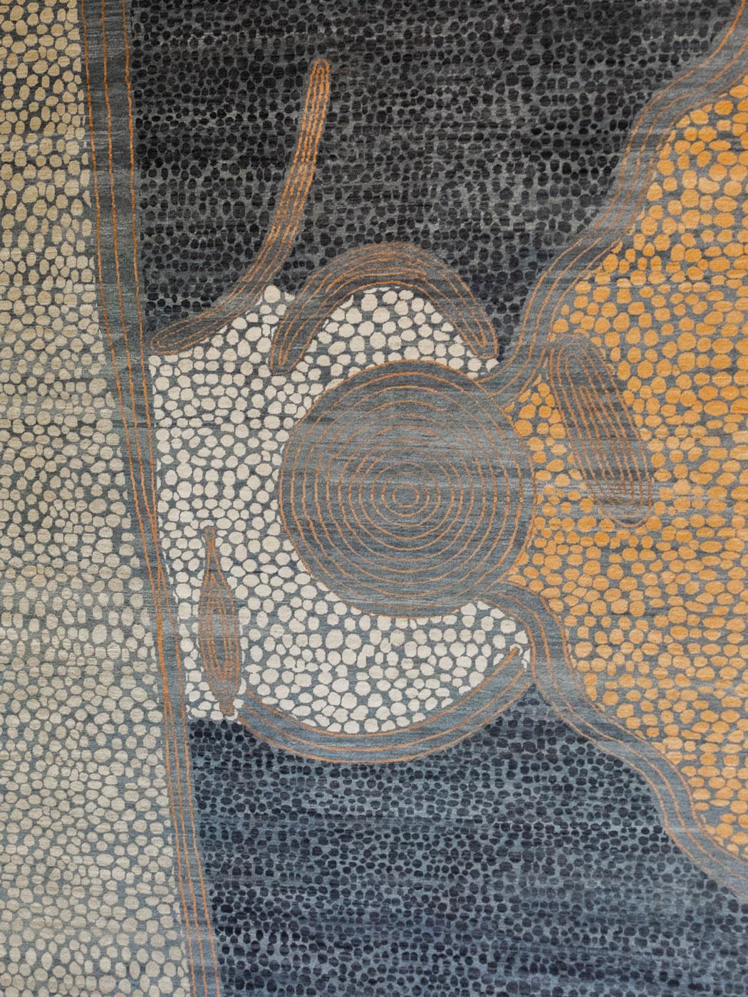 This abstract blue, gray, and orange wool Persian carpet with a pattern resembling pebbles, from the Orley Shabahang Dream Collection, is a striking blend of color, texture, and cultural storytelling in an 8' x 10' size. Inspired by the vivid,