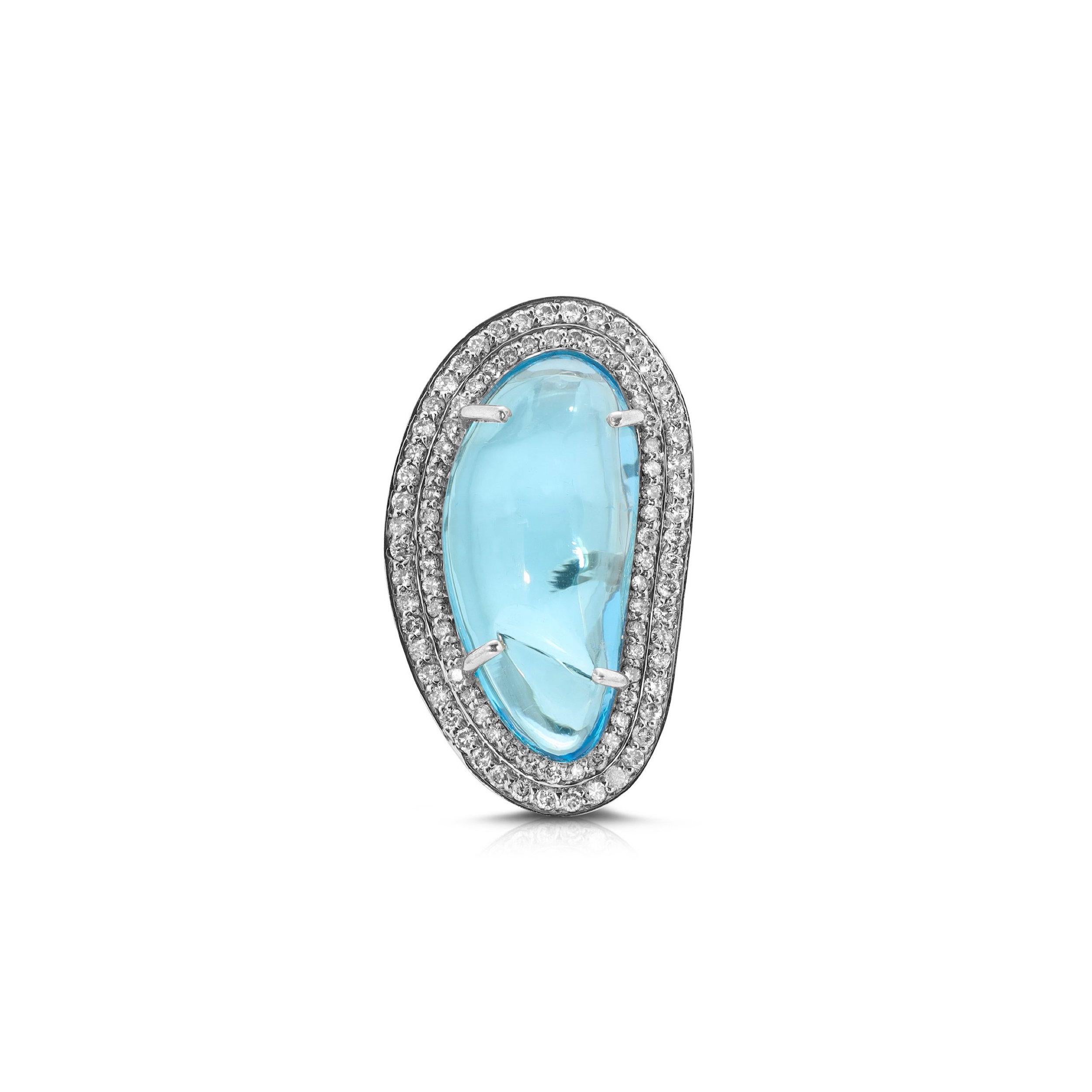 Make a statement with this gorgeous 18 Karat White Gold polish over Silver cocktail ring featuring an alluring Cabochon Blue Topaz set with sparkling White Diamonds in a stunning abstract design.