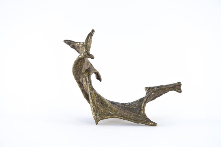 Though petite, this bronze sculpture is highly expressive in its twisted, batwing-like form. Small enough to adorn a desk or bookshelf and poseable in a variety of positions, it's sure to stand out in any collection. This piece does not appear to be