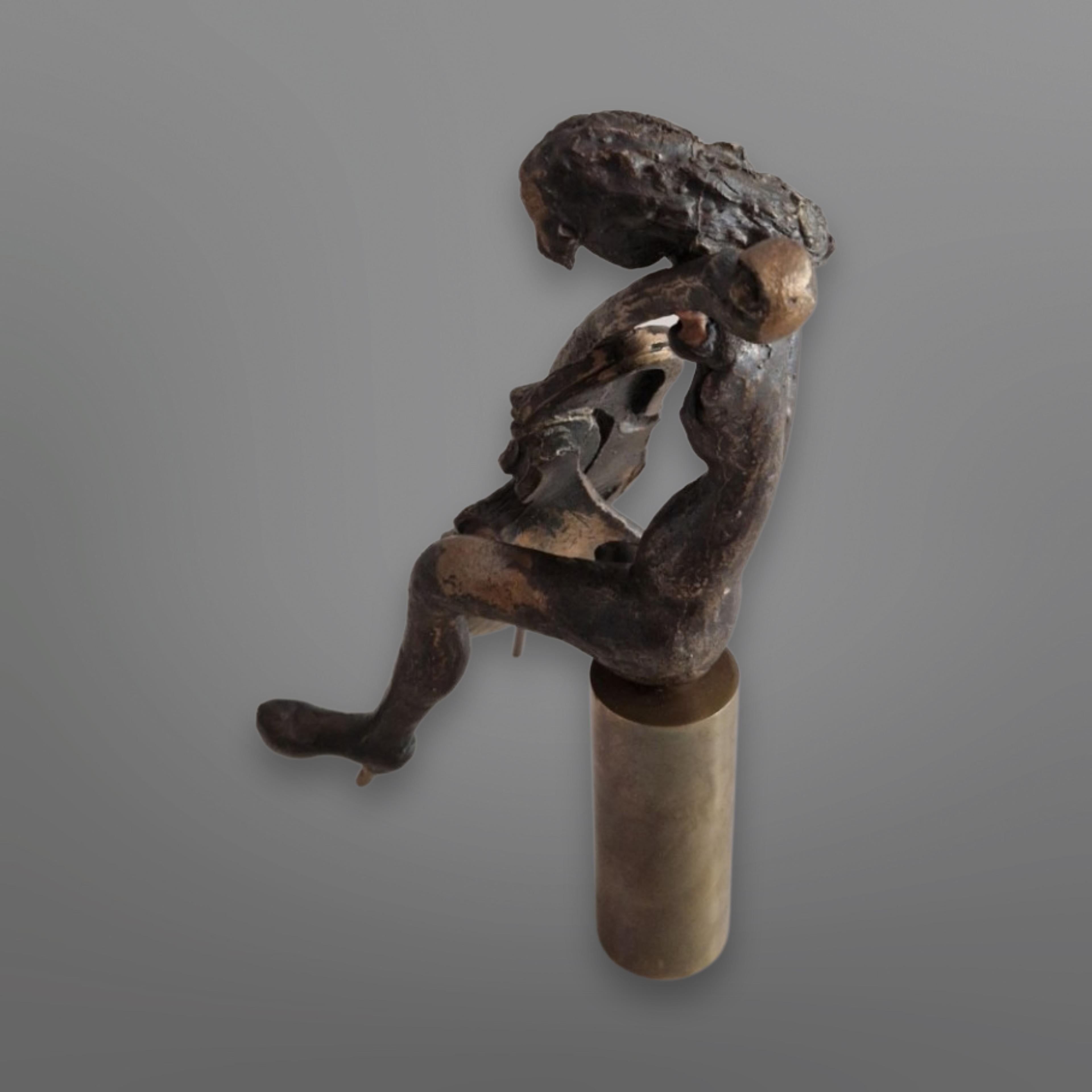 Small cast bronze  abstract statue. It depicts a female cello player sitting on a round stool. It is designed in the style of Yves Lohé. No signature or markings visible. 

- Abstract art uses visual language of shape, form, color and line to create