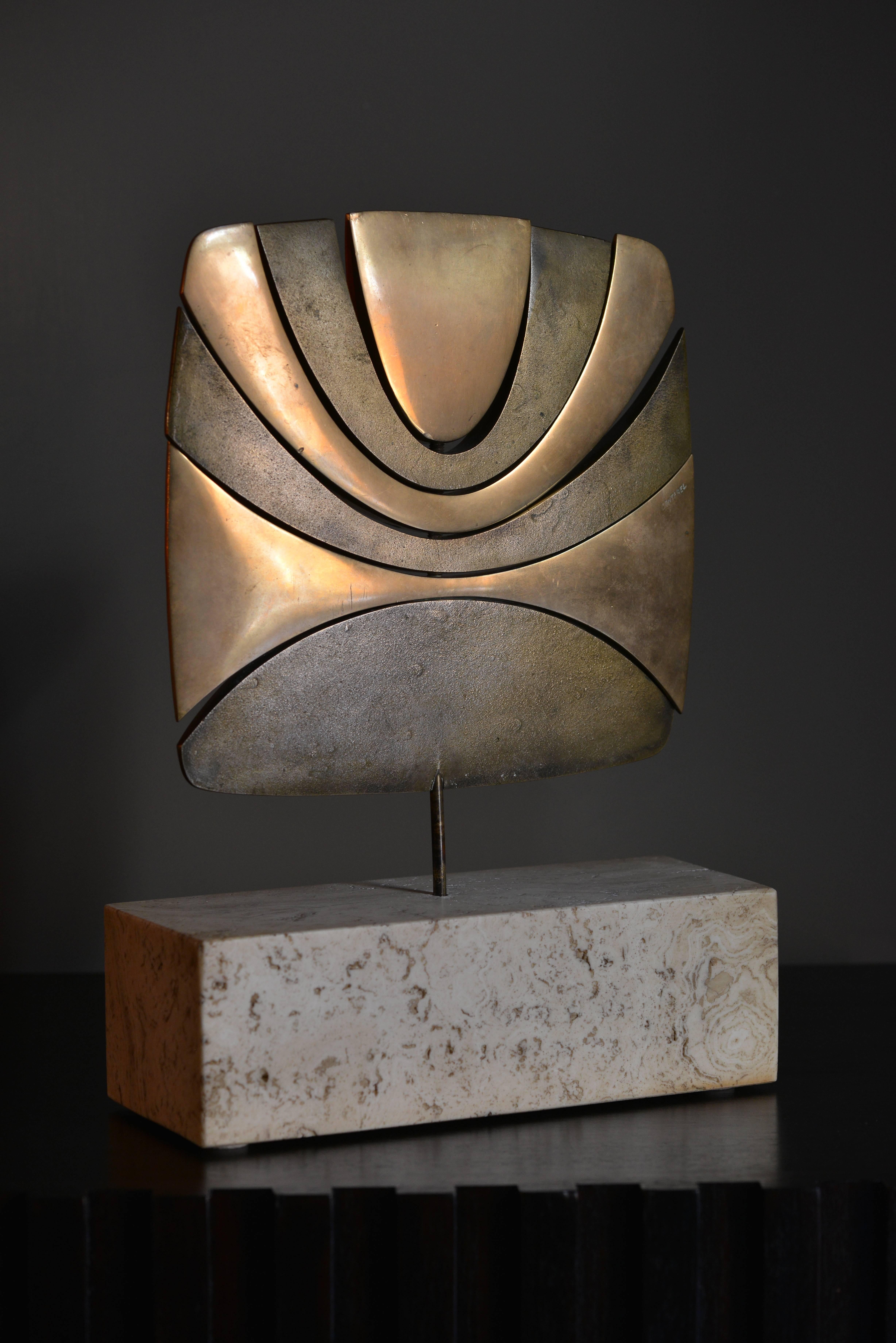 Bronze sculpture by the French artist Alain Cantarel. The different bronze elements (some have a polished warm surface, some a rough darker one) can rotate around the central axis that holds the sculpture in the travertine base.