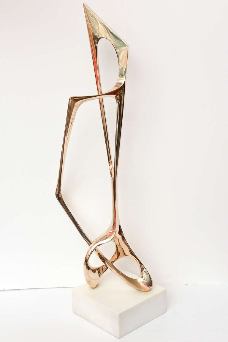 The sensuality, poetic and lyrical movement of this amazing polished signed abstract lyrical bronze sculpture by Antonio Grediaga Kieff that looks like rose gold sits on a white marble base. It is untitled and in a very small edition of 6/6. It