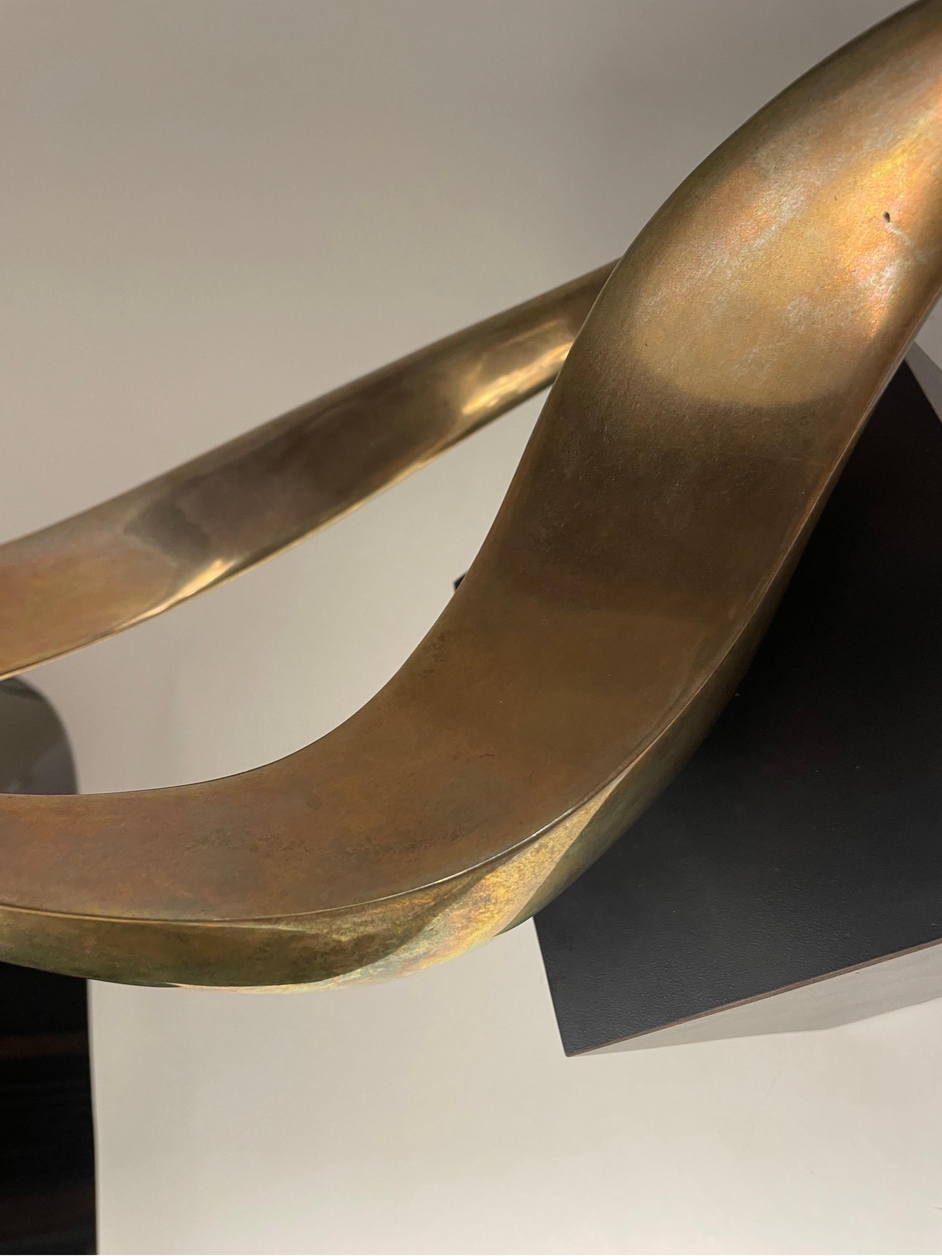 This is a great looking bronze abstract sculpture by Robbie Robins on a moveable black plynth 
20 th century 