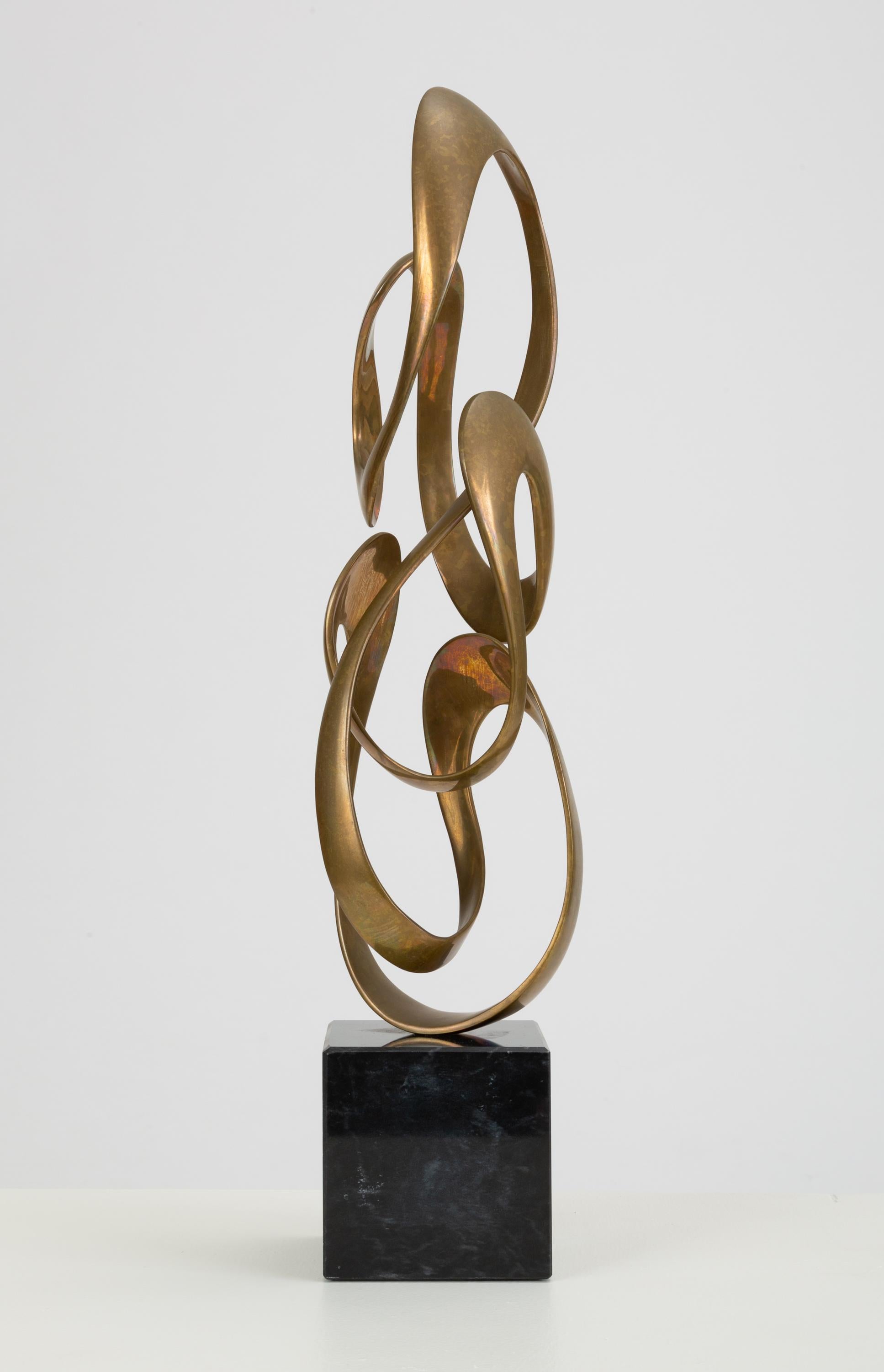 Carmel, CA-based identical twins Tom and Bob Bennett created mounted bronze sculptures, both abstract and figurative, at their studio through the 1970s, 80s and 90s. This abstract piece with a ribbon-like, Moebius strip construction is typical of