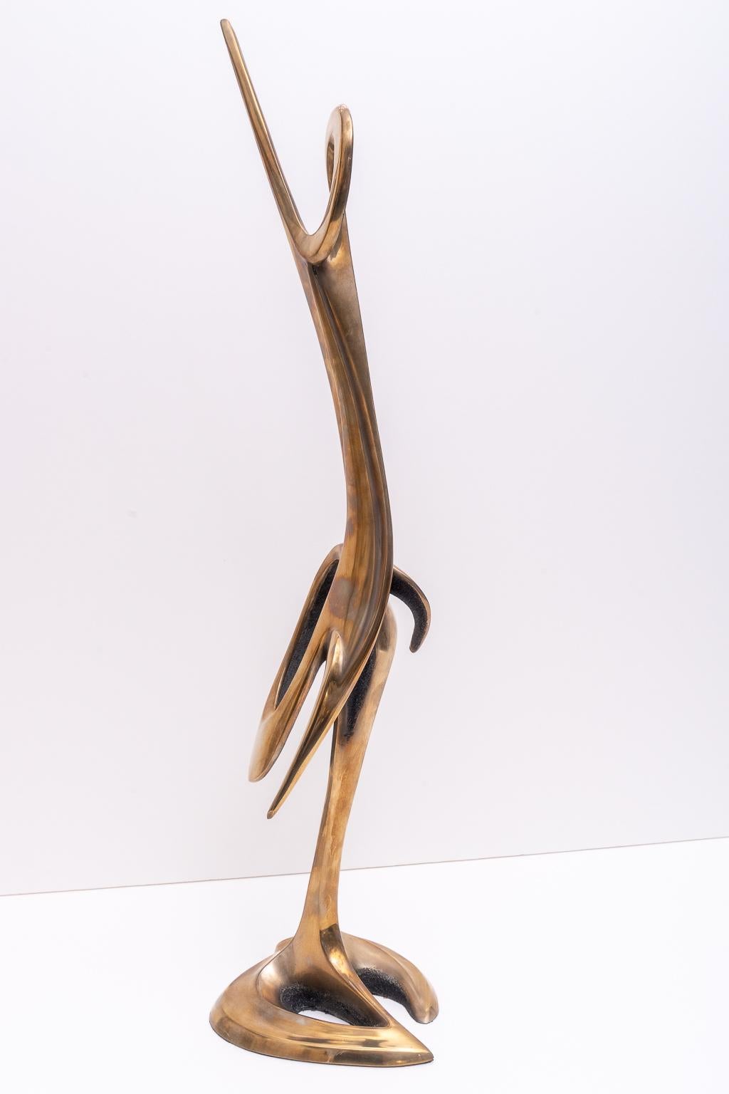 This stylish and chic bronze sculpture by the American sculptor Robert Bennet dates to 1985 and was acquired from a Palm Beach estate. The stylized form is that of two cranes intertwined.
