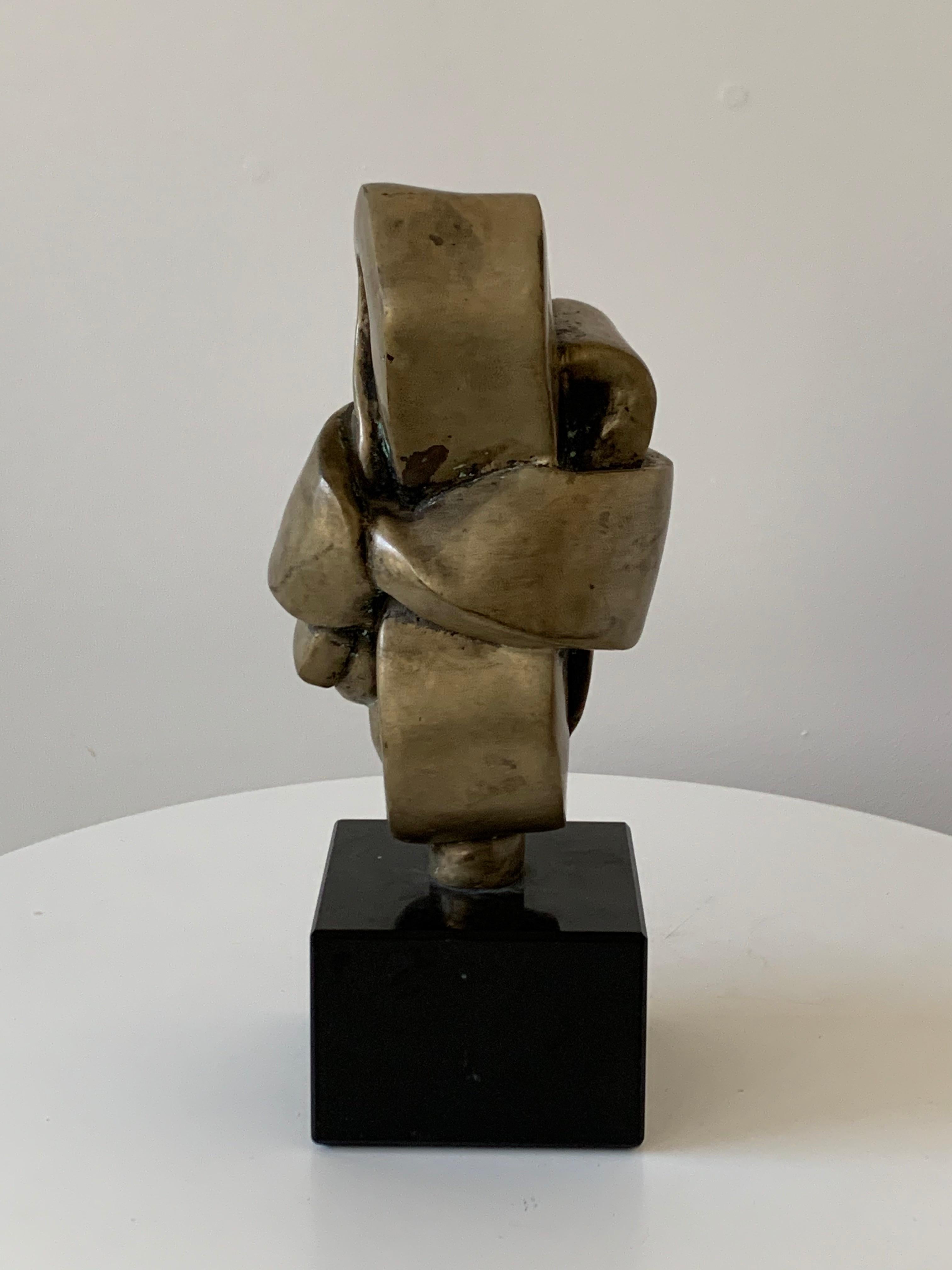 Tabletop bronze sculpture on a black marble base.
Abstract folded knot. Good from all sides. Minor imperfections on surface are not losses, but original.
Mounted on original base (2.5 x 3.5 x 3.25)
Unsigned.
Provenance Allan Stone Gallery, NYC.