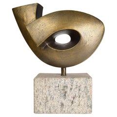 Abstract bronze sculpture on granite base with organic, geometric form