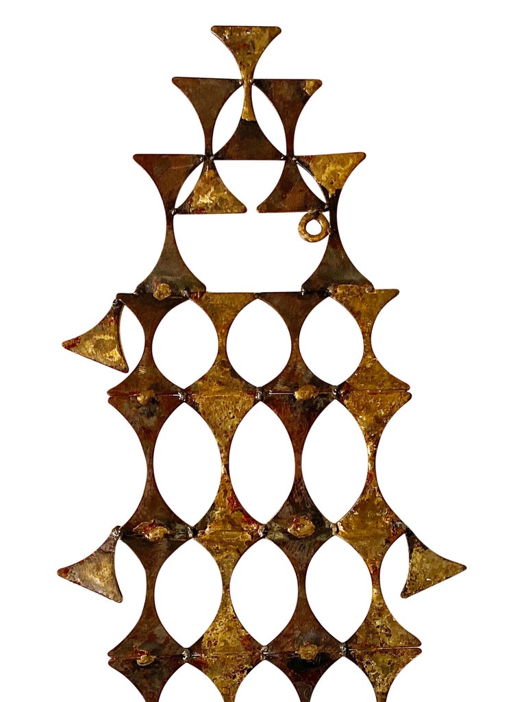 This Brutalist wall art sculpture is absolutely stunning in the light, the brass just glows! This is a perfect focal point for any room with its abstracted geometric design. There is a signature although we have not been able to identify the artist.