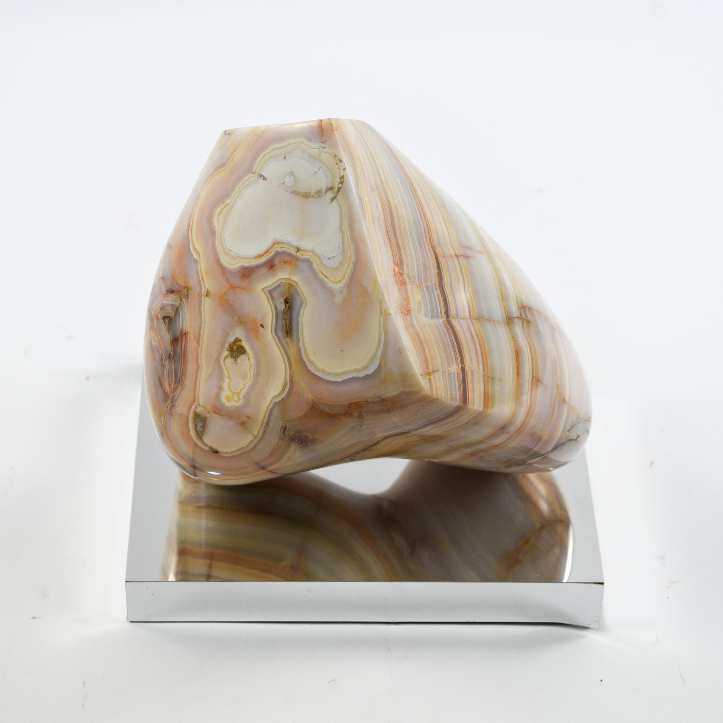 This beautiful marble sculpture has a fresh, modern appearance. Resembling an abstract lower torso, this piece is full of sleek, smooth lines both in the design of the piece and within the marble itself.
