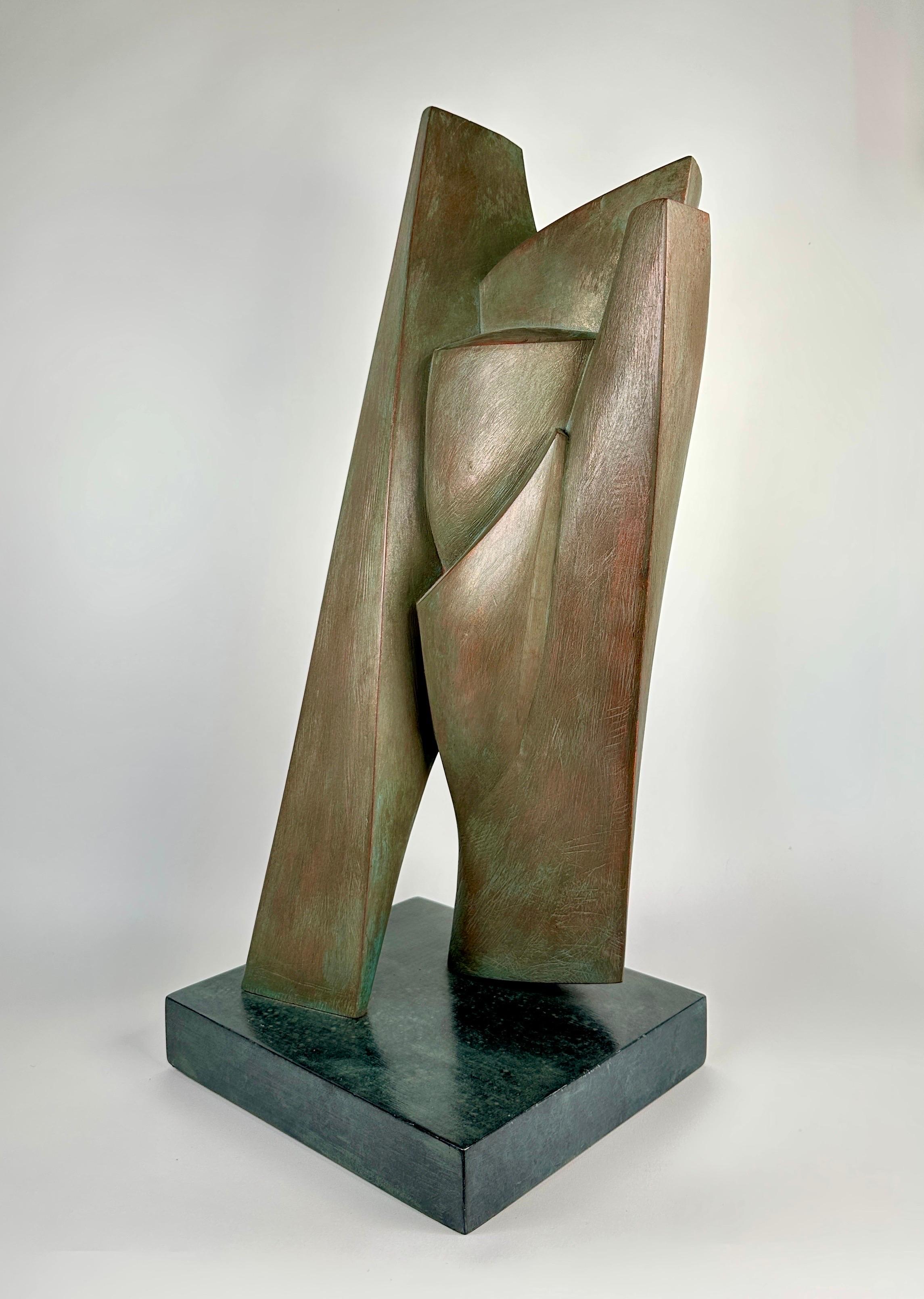 Carved wood sculpture by Elaine Lorenz with applied patination. Mounted to a lacquered wooden base.