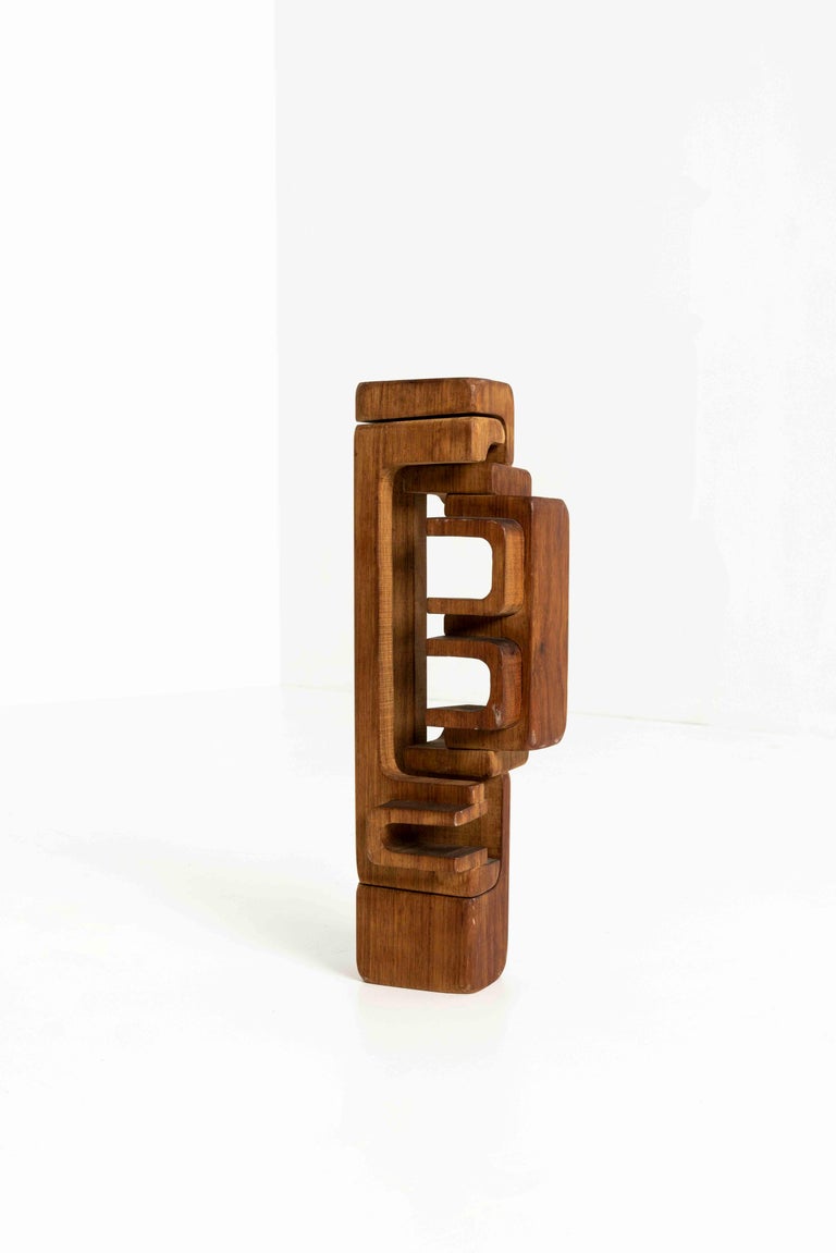 Abstract carved wooden sculpture by Brian Willsher from 1976, the United Kingdom. This beautiful artwork consists of two carved, elements made of iroko wood. They fit together but are also flexible in their position toward each other. The sculpture