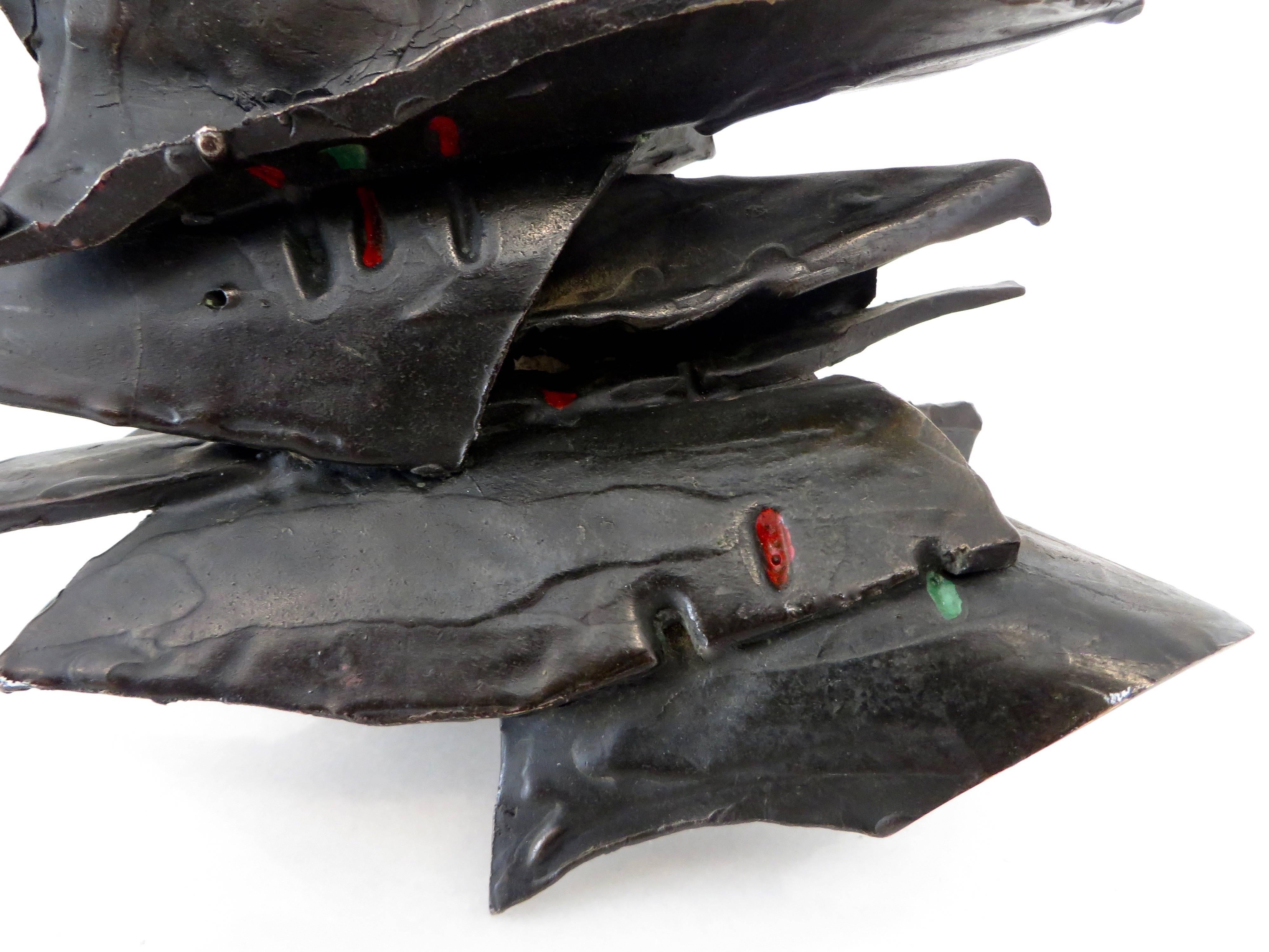 An abstract cast bronze sculpture composed of many abstract leaves of bronze with touches of color on each leave.
This sculpture can be posed in many different positions.
Collected in California.