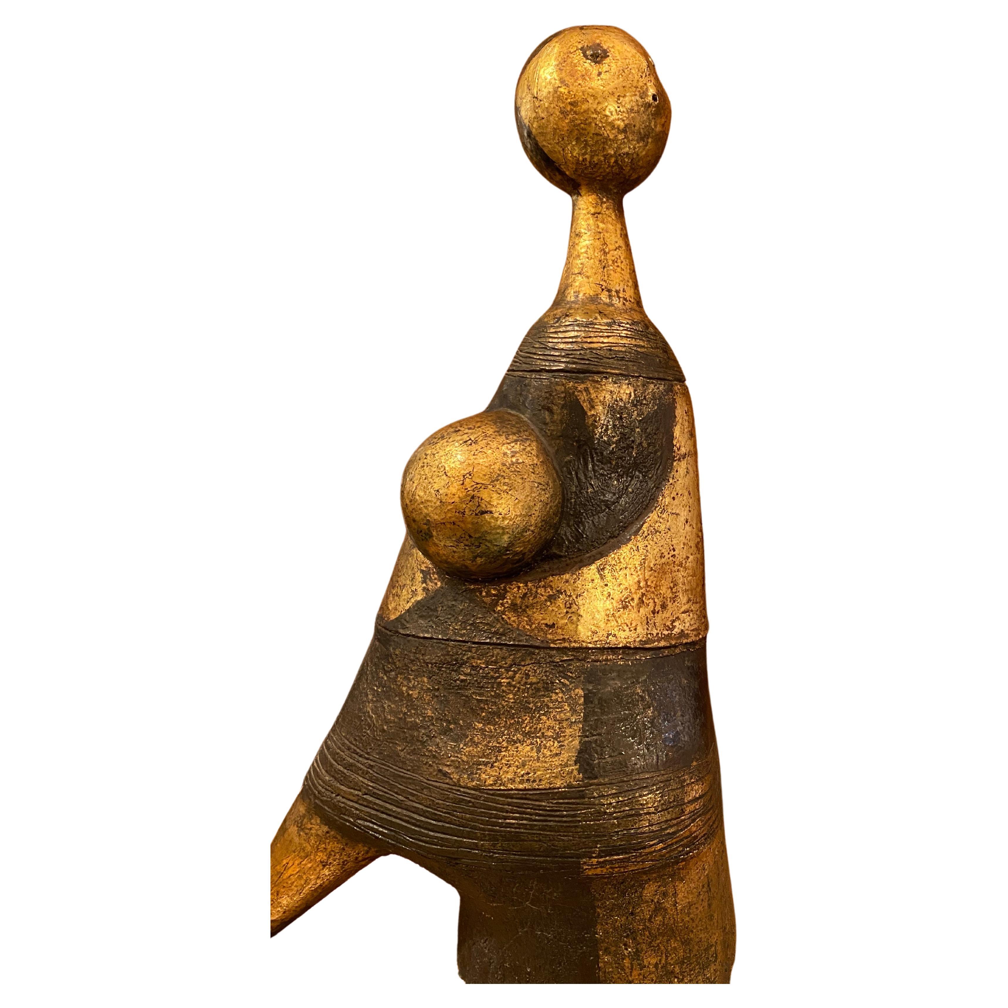 A large piece unique ceramic abstract sculpture of a woman, mother and child made by the Belgian folk artist  Jhan Paulussen, dating from 1962, not signed.Fired and glazed ceramic in gold and earthy brown tones