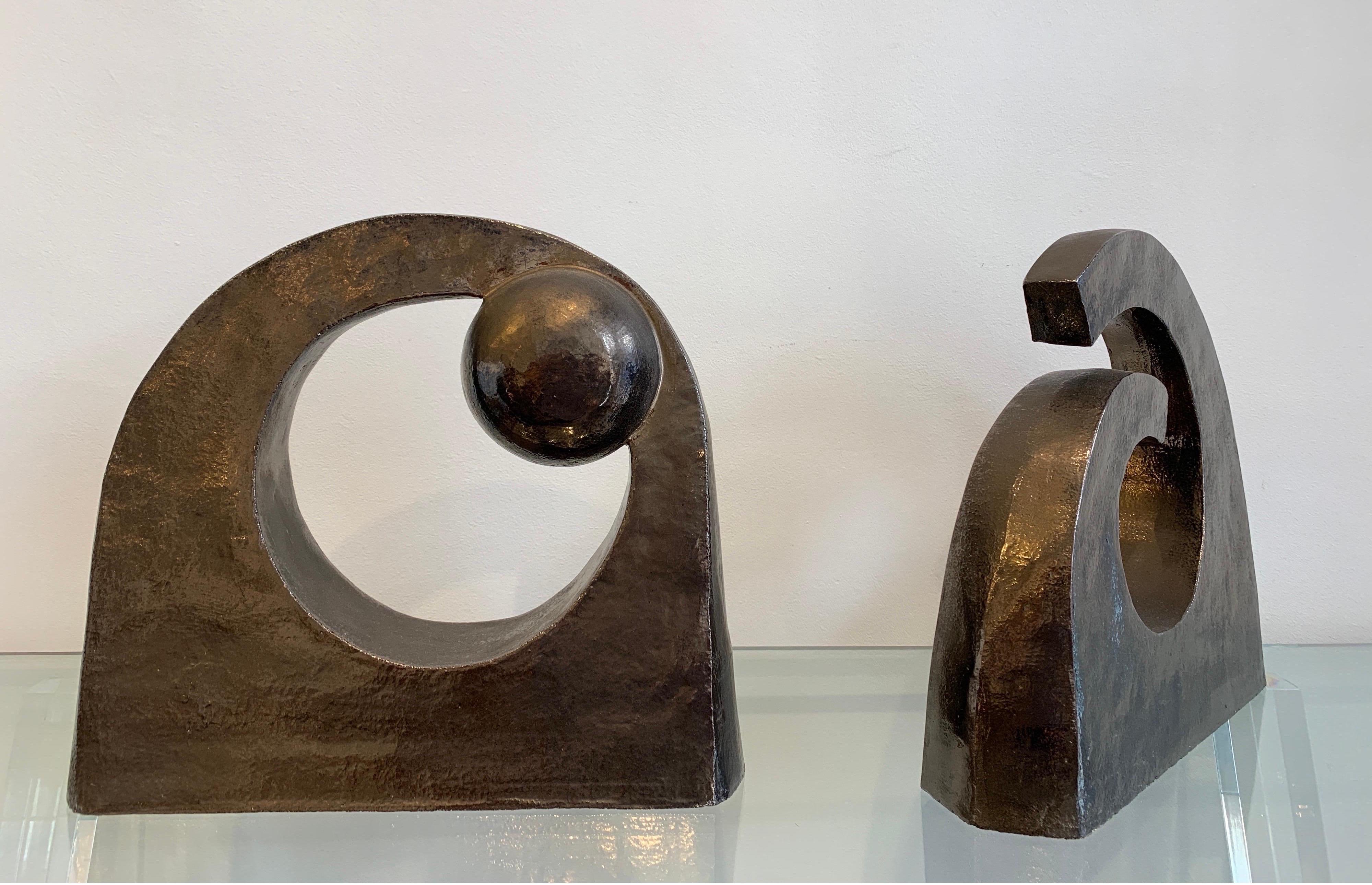 The present pair of Abstract ceramics is probably of Belgian origin. They form an ensemble, on being open the other closed with an inner sphere. Earthenware is the material with an oxidized metallic coating that simulates copper laying. They are