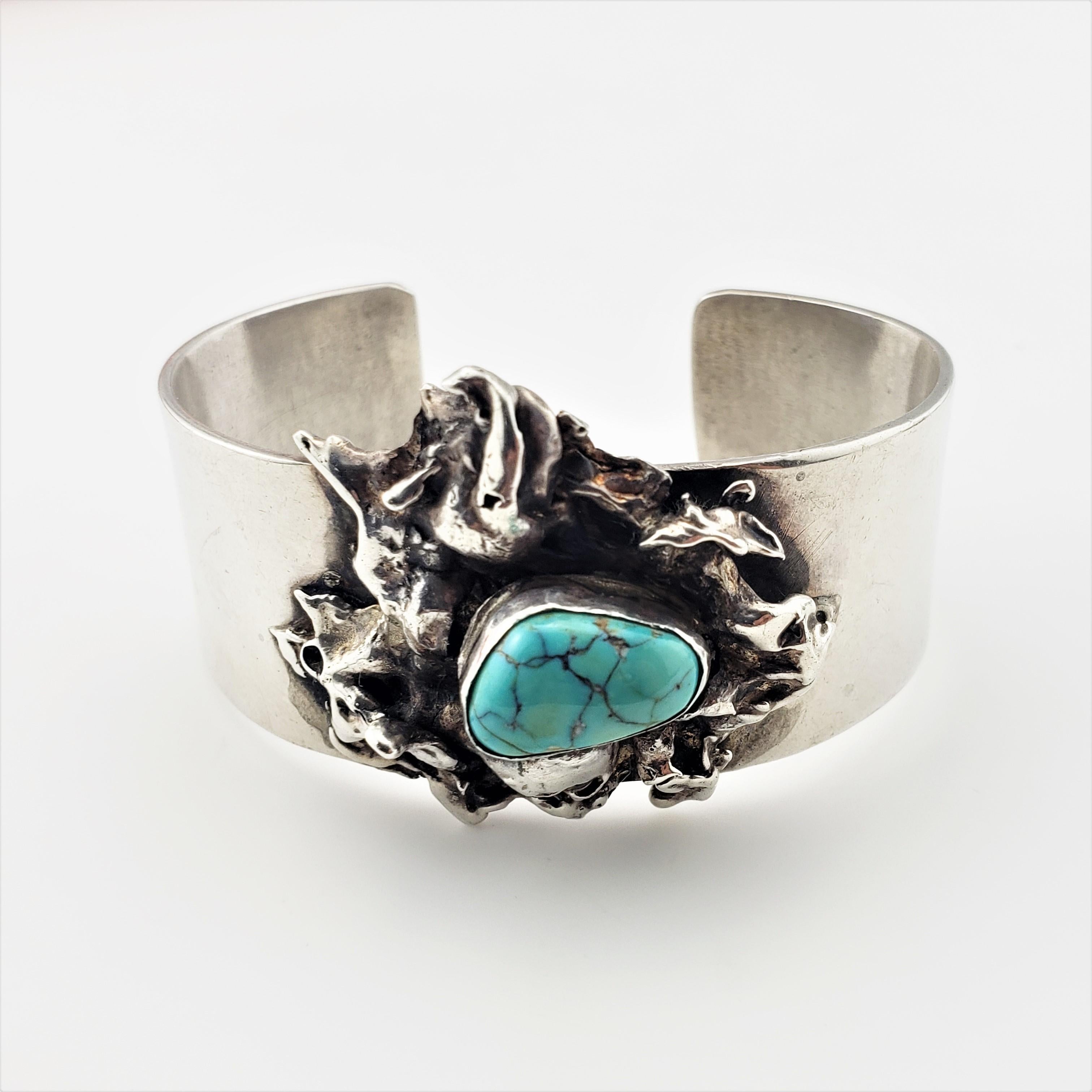 Abstract Dripped Sterling Silver Turquoise Cuff Bracelet-

This lovely cuff bracelet features one turquoise stone set in beautifully crafted sterling silver.

Stone:  14 mm x 9 mm; sits 11 mm high

Bracelet Measurements: 5  1/16 inches end to