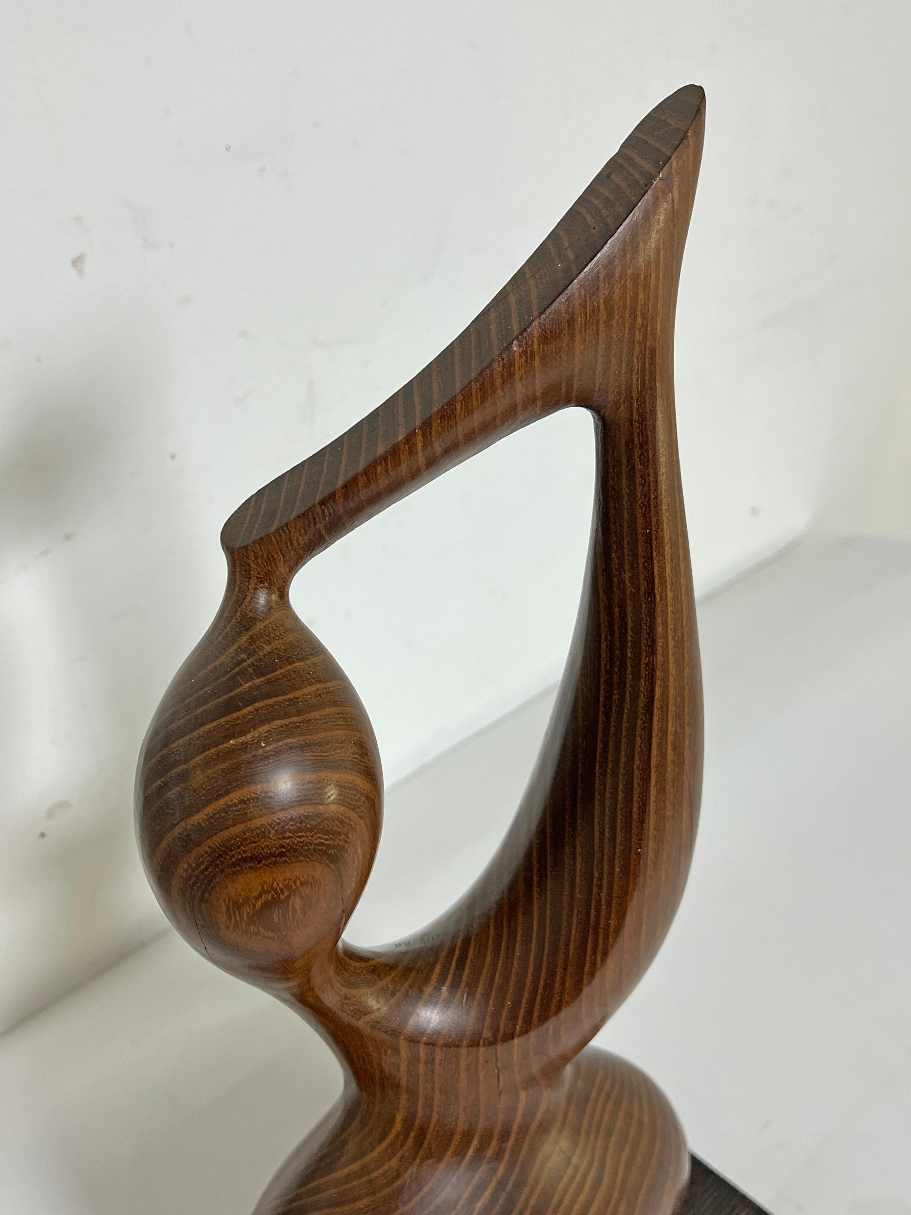 A teak abstract figurative sculpture (23