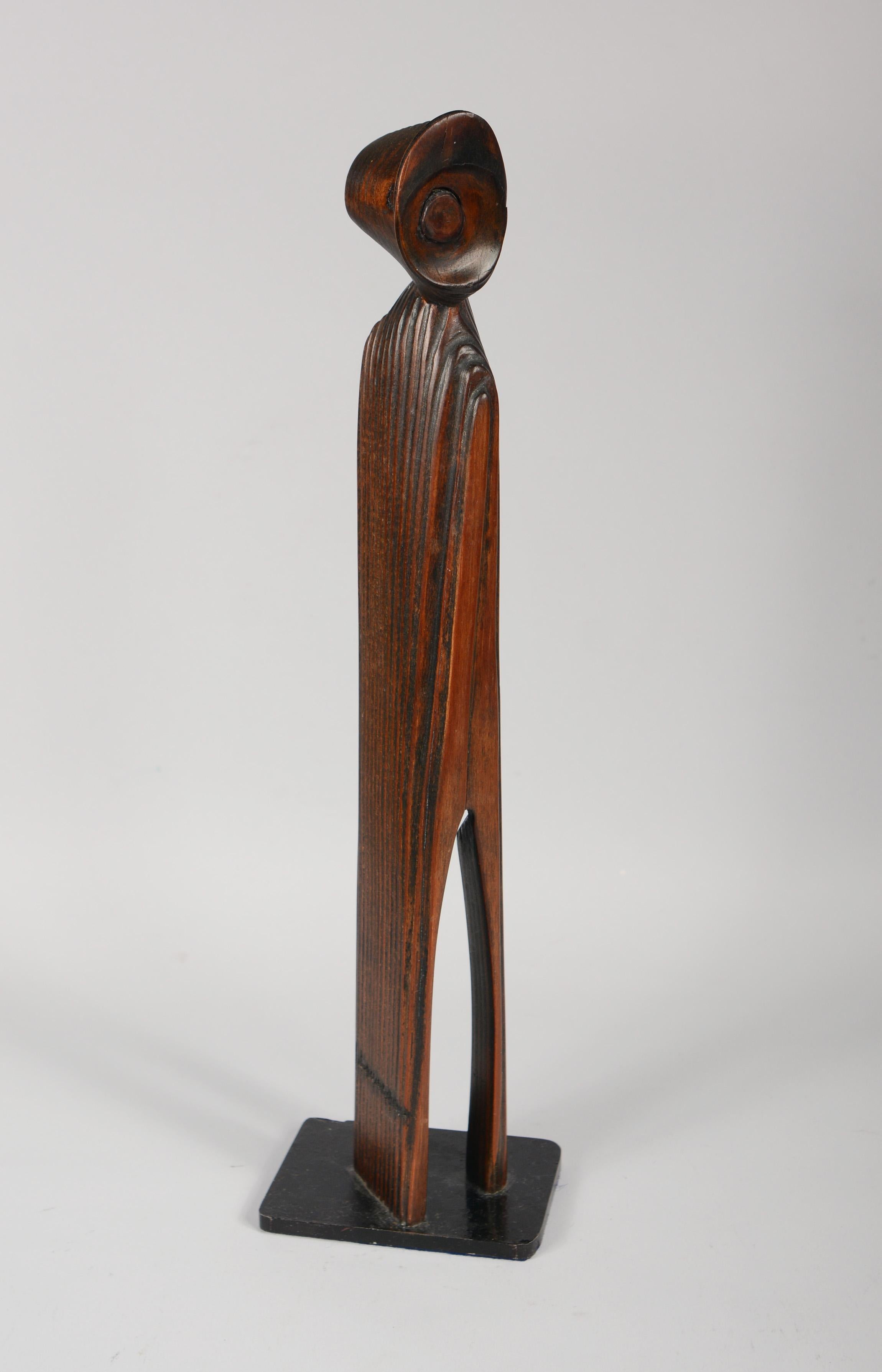 Carved wood abstract sculpture on a iron base. This sculpture has a combed wood grain giving it a ribbed effect. This is from the estate of an artist although not a work of his.