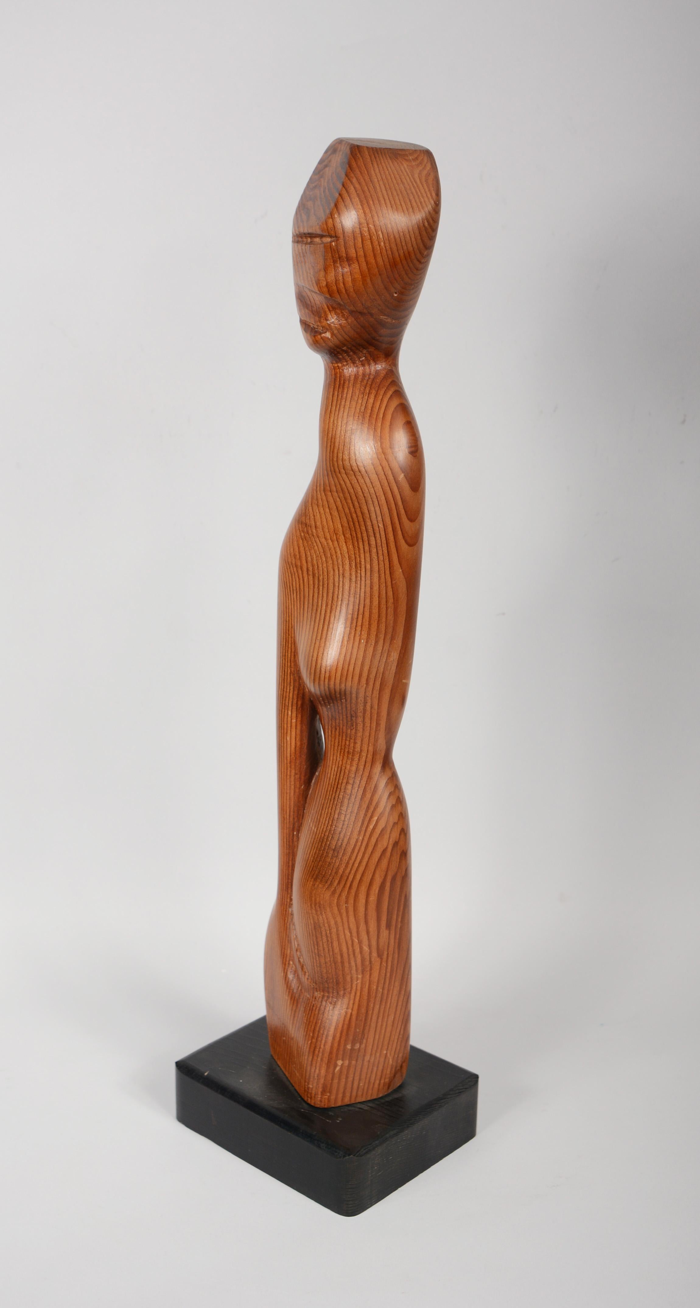 Abstract carved sculpture of a woman figure. This is from the estate of an artist but likely by another artist.