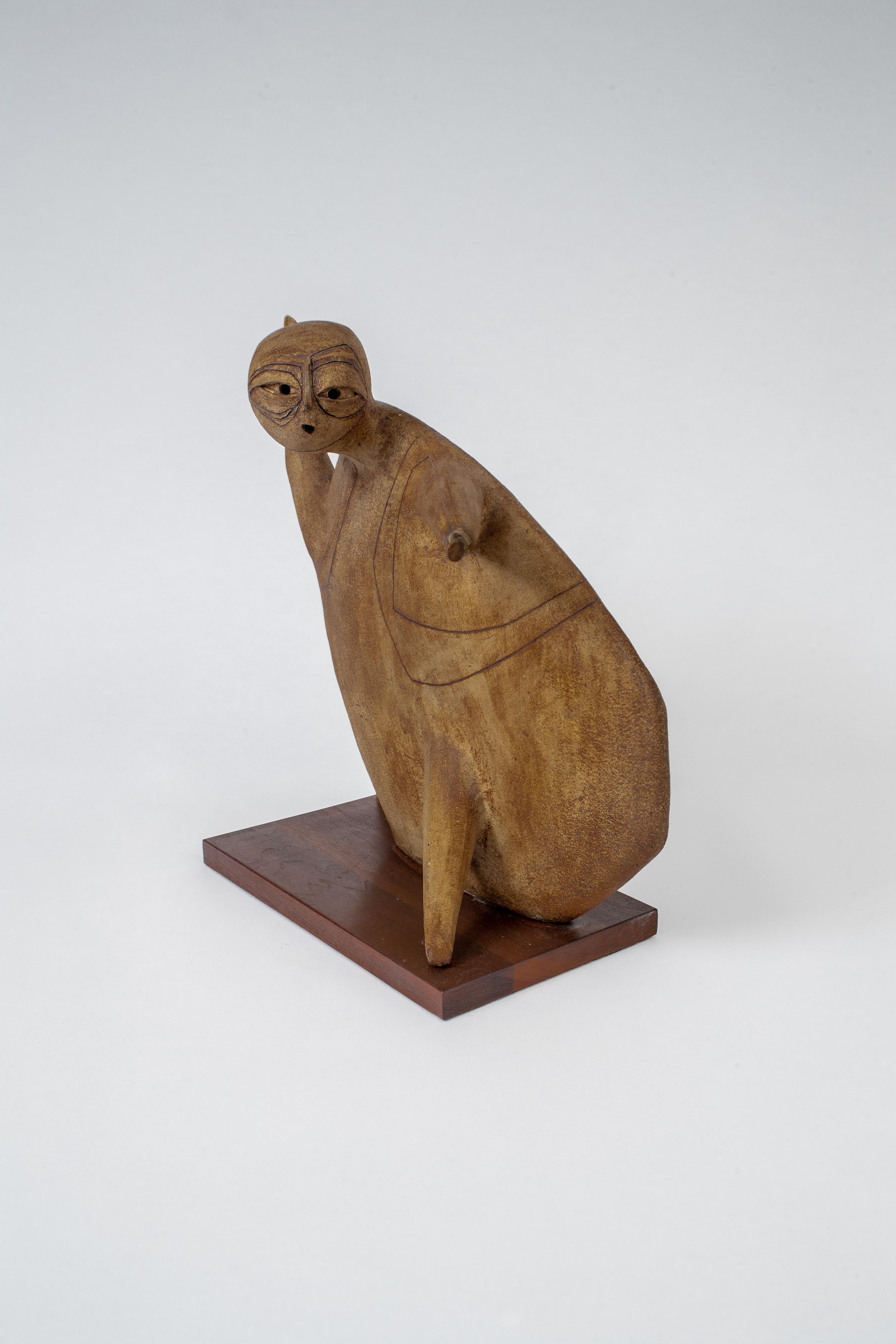 An abstract martial art figure in Grés on a walnut base.