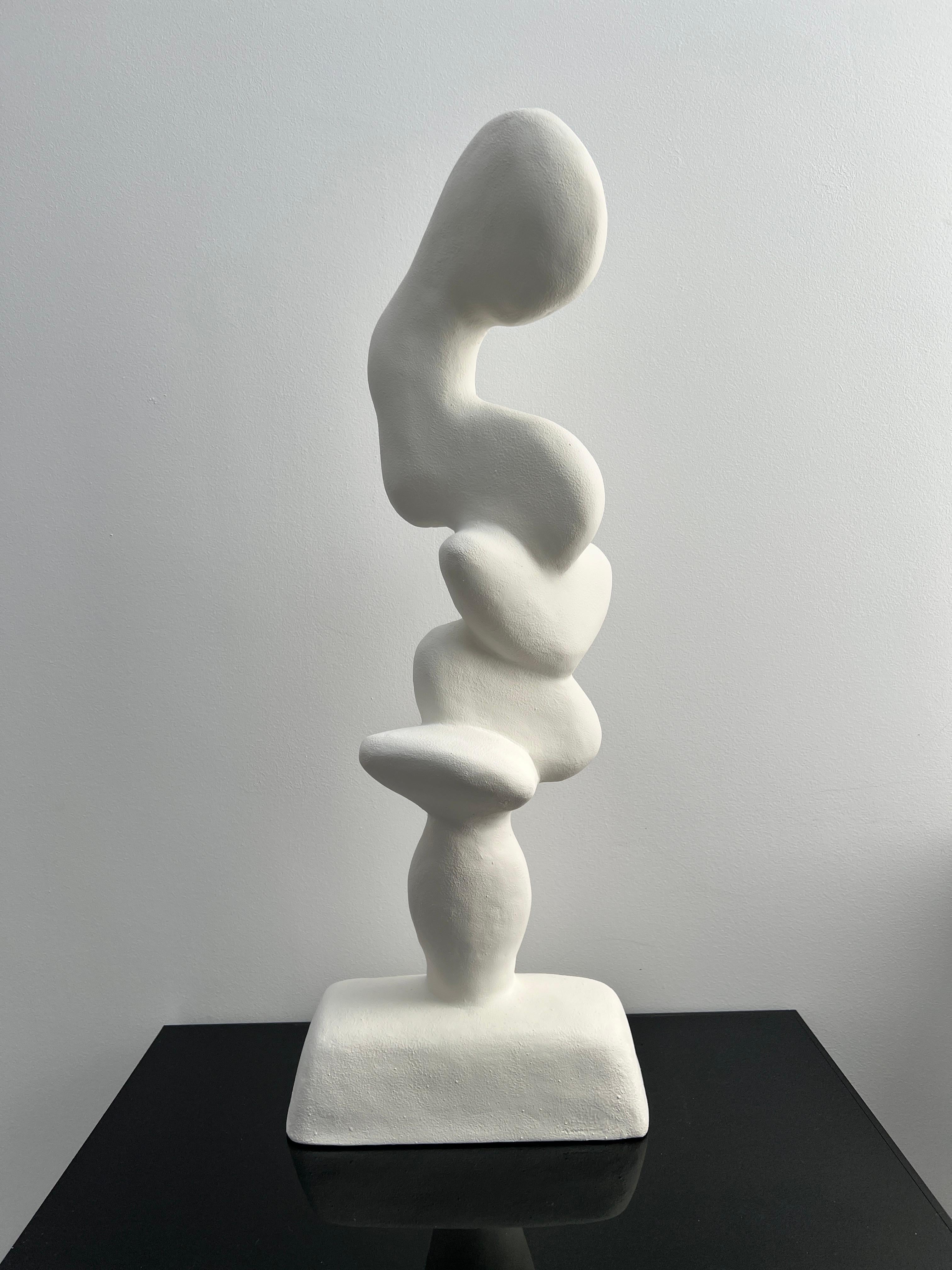 
A one of a kind sculpture of an abstract figure  in white,  handcrafted in full bodied gypsum reinforced with fibreglass matting and jute. The creative process takes multiple stages, from sculpting the original abstract form, followed by repetitive