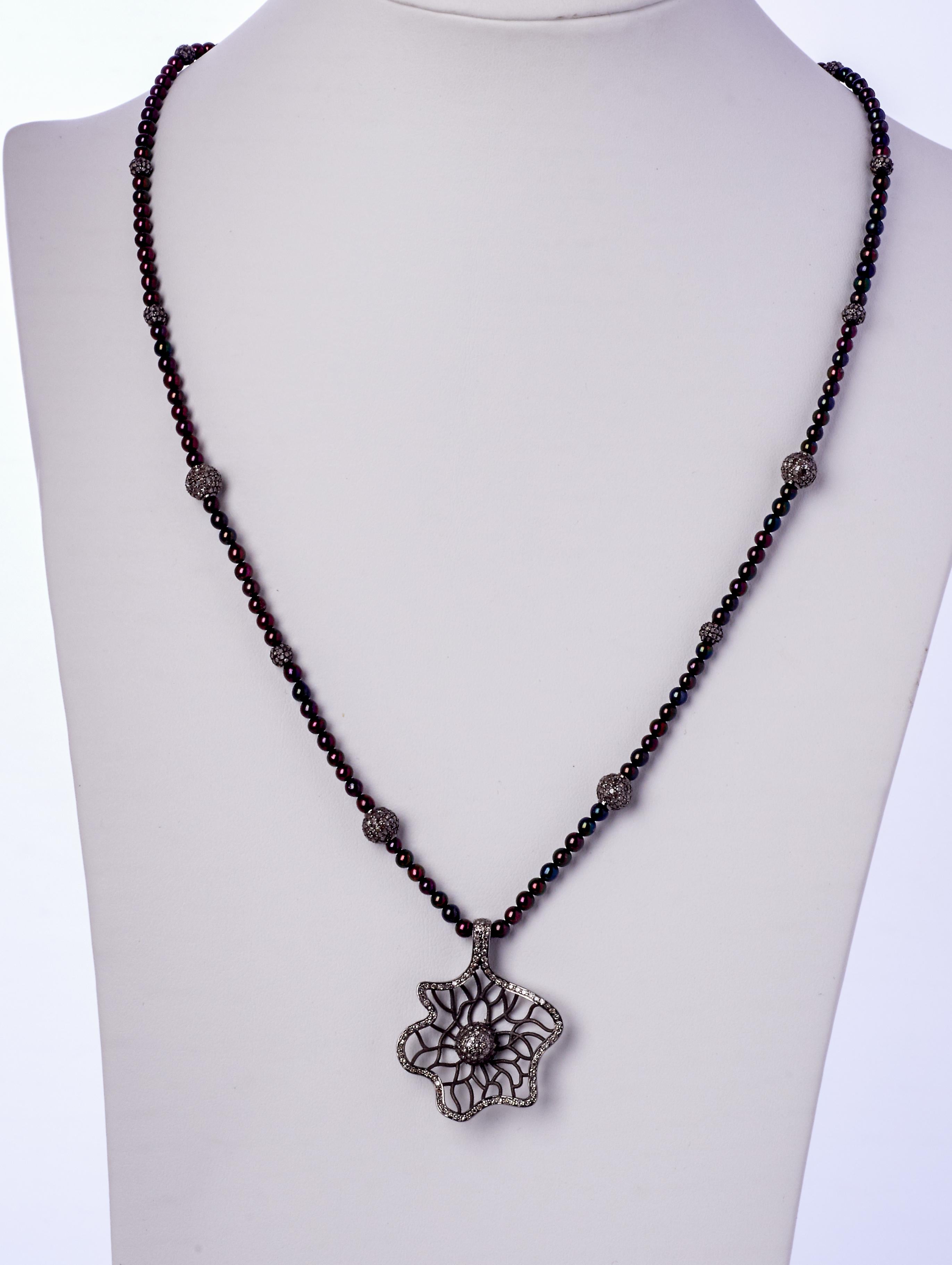 A whimsical floral diamond sterling silver pendant is suspended on this iridescent colorful twenty four inch strand of 3-1/4mm genuine Akoya pearls.
Twelve twinkling diamond sterling silver beads create glittering station along the strand. Created