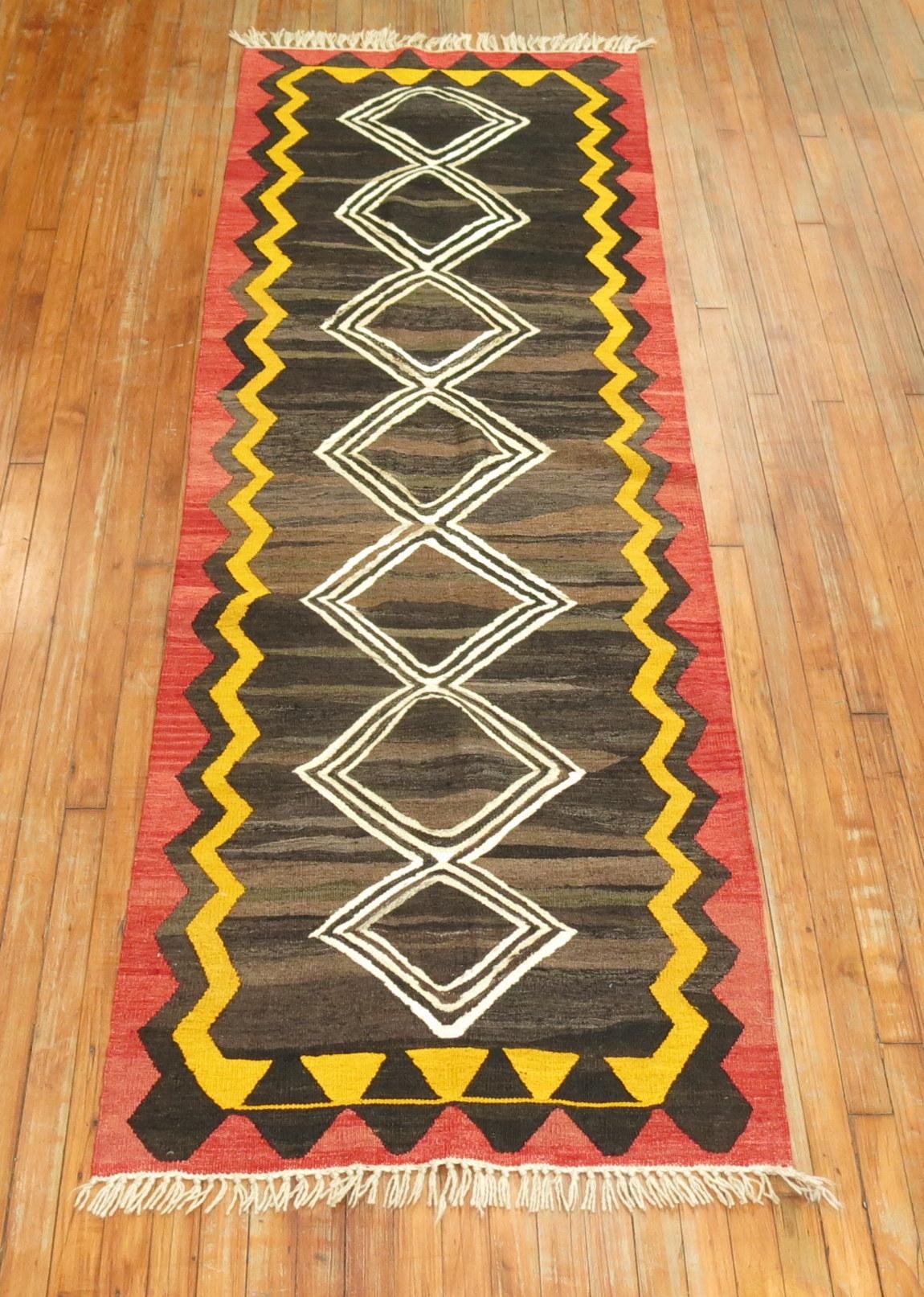 A one of a kind Central Asian Kilim runner with abstract geometric elements.