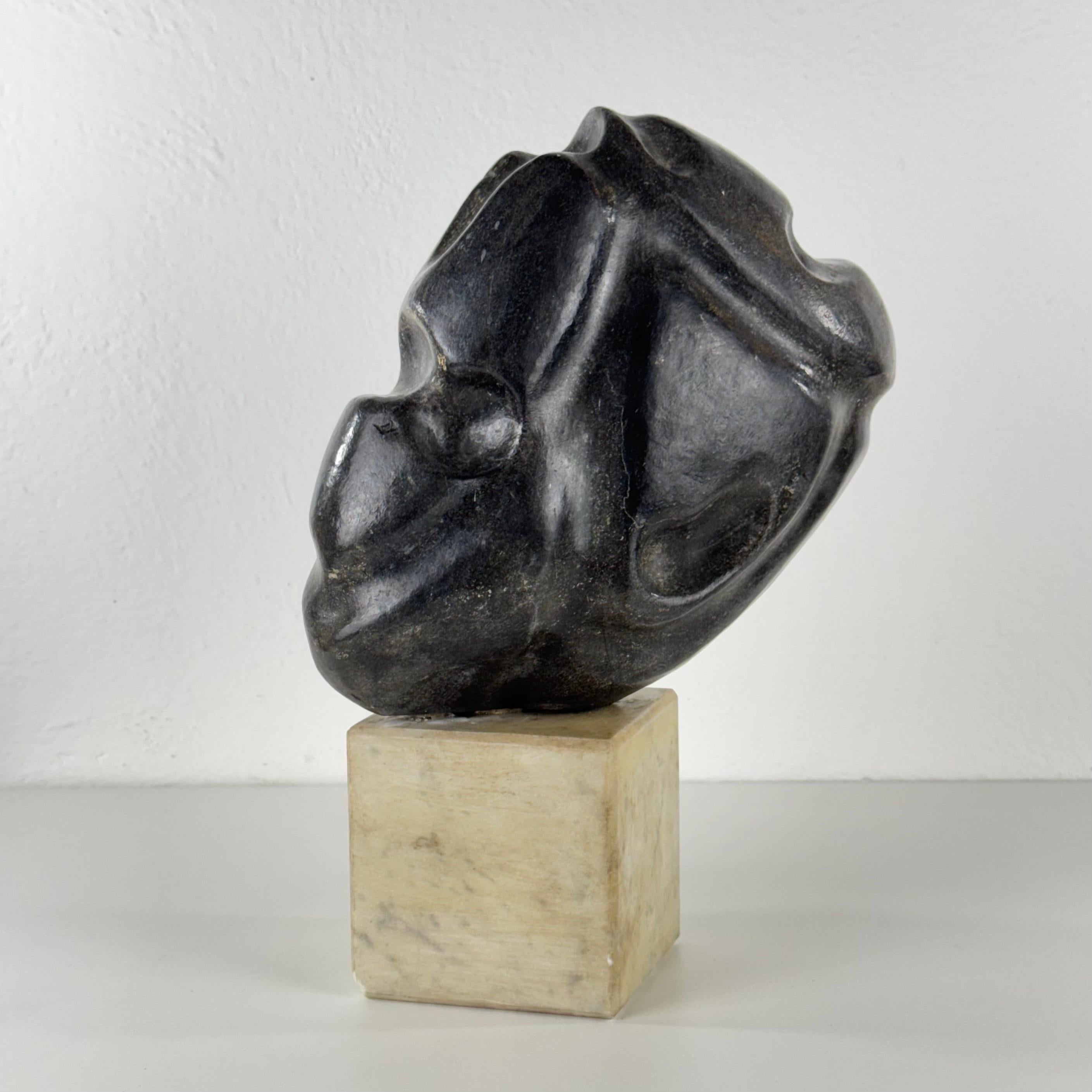 An extraordinary marble sculpture by Italian artist Pietro Cenedella, an abstract head-like form balancing between figuration and pure gesture. The piece is entirely carved from Carrara marble — the base left in its natural creamy hue, while the