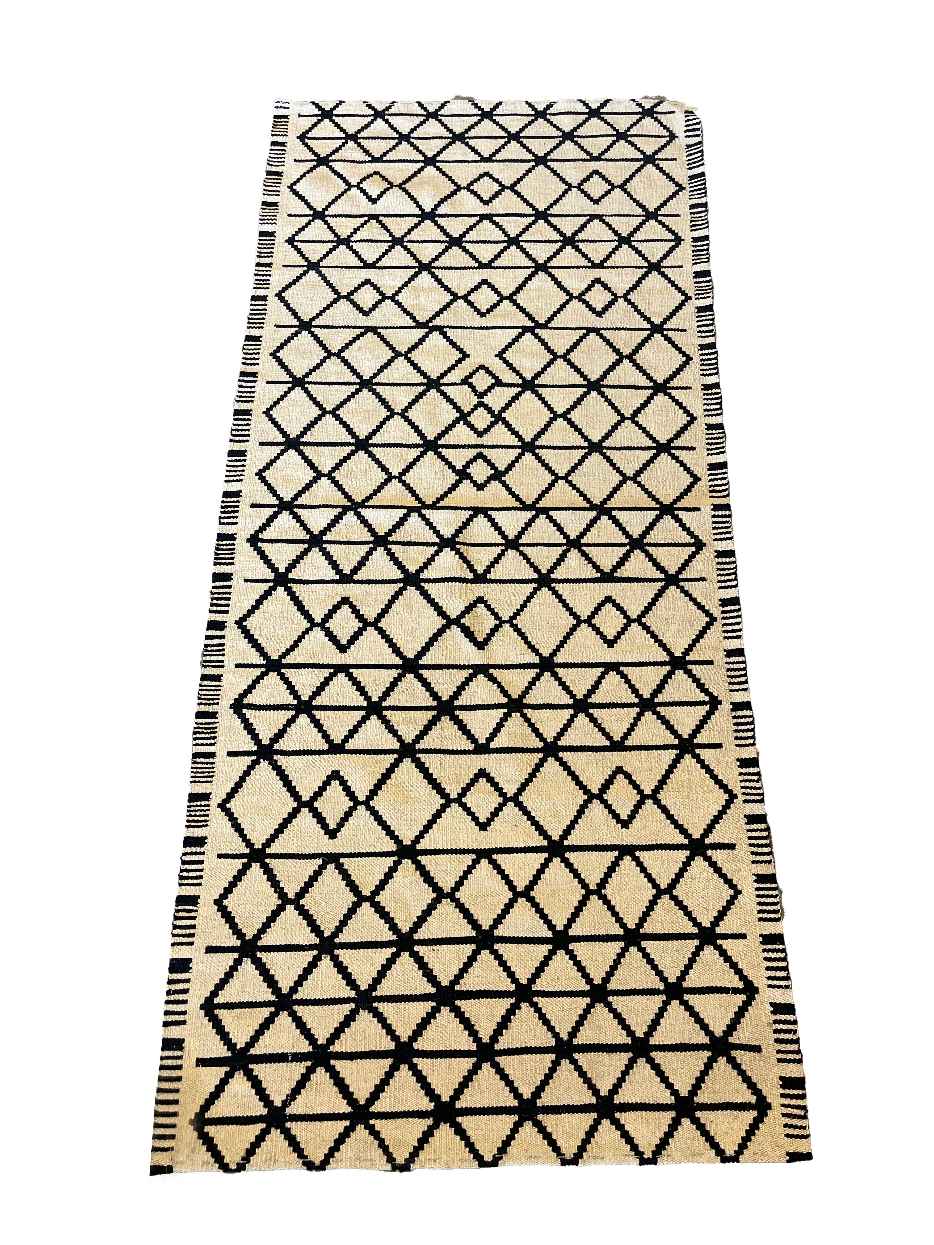 This modern handwoven wool kilim is a great example of handwoven carpets from Afghanistan. The design is a unique Scandinavian style pattern, simple yet beautiful this rug is sure to make a great accent rug for any room in your home. Easily style