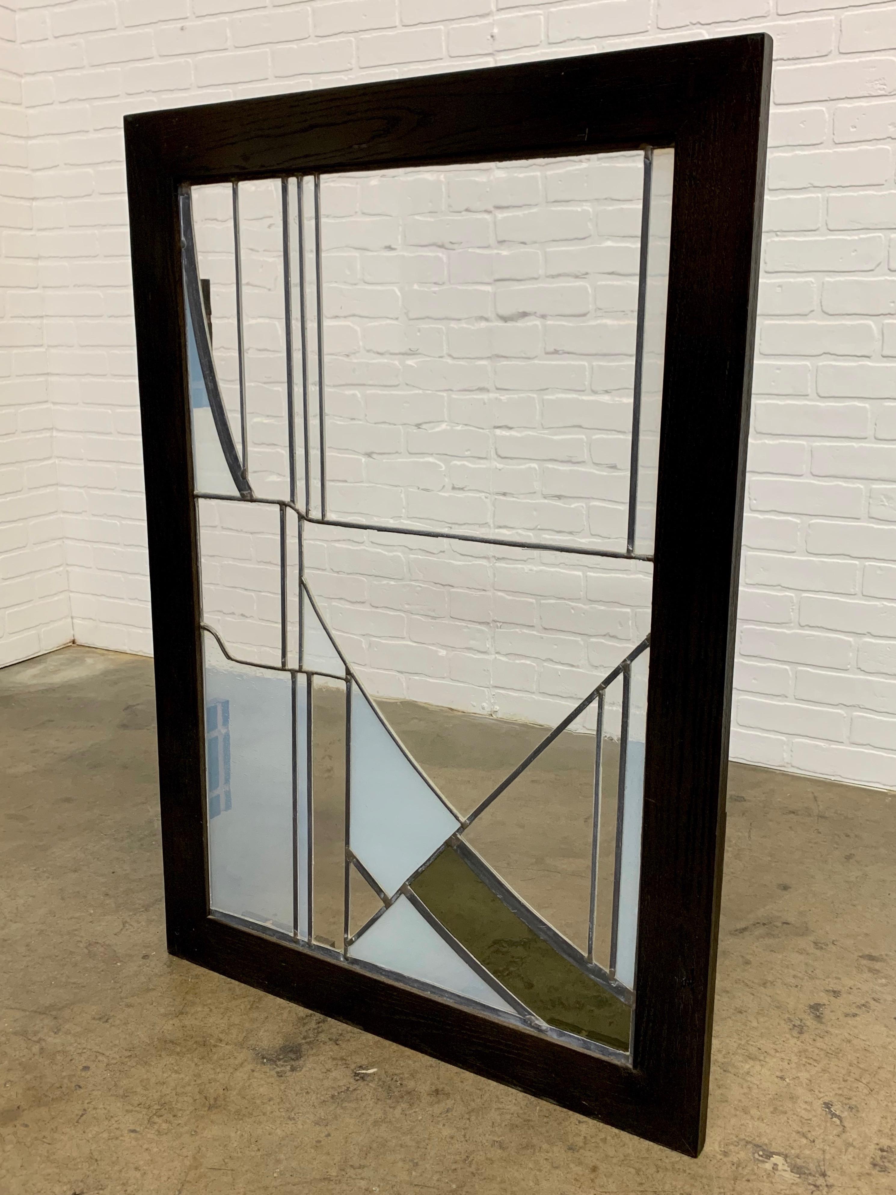 Studio crafted stained glass abstraction. A combination of wavy clear, smoked and milky glass. This piece has been custom framed for display.



  