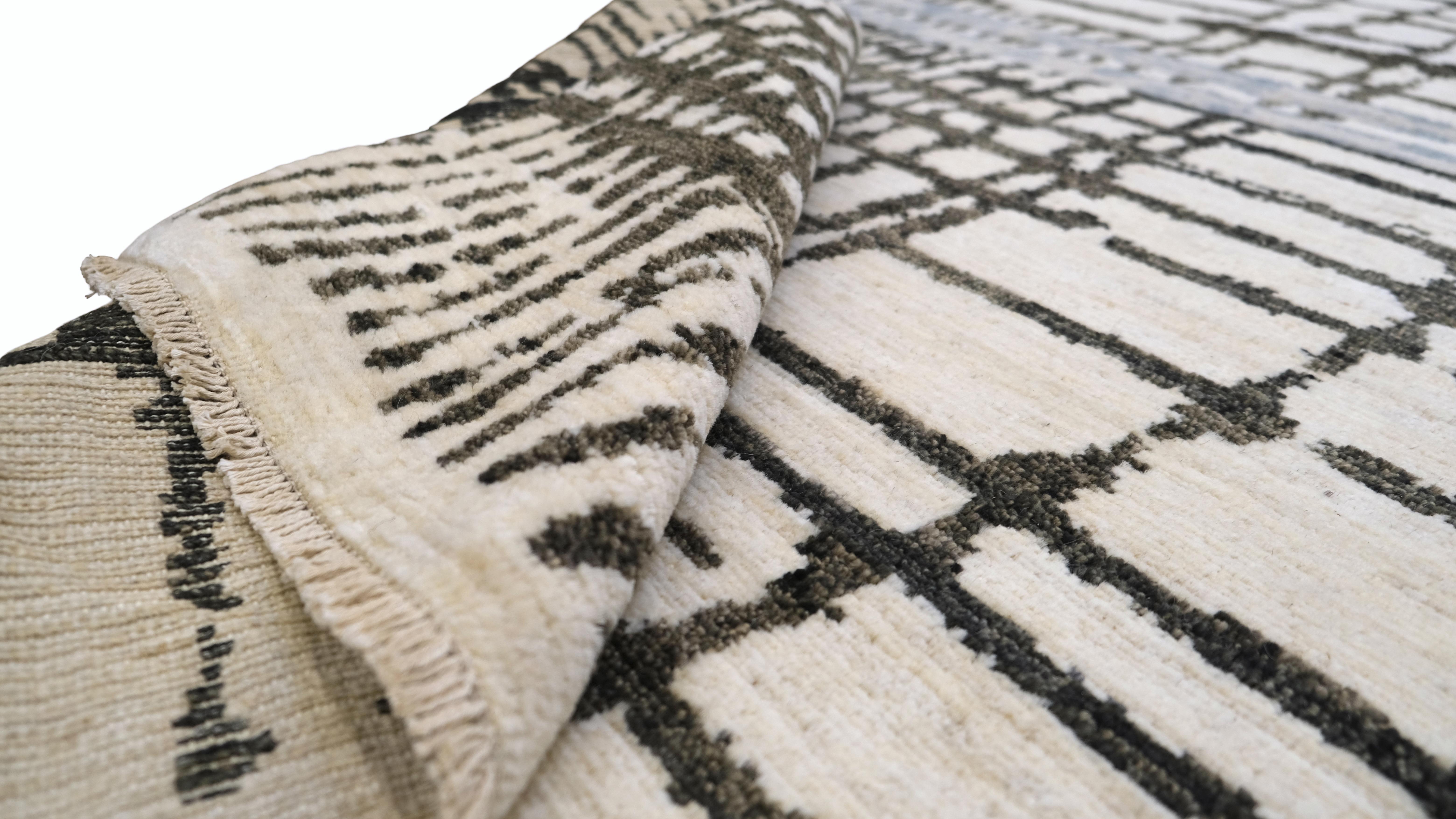 Elevate your living space with this unique hand-knotted wool rug, featuring a contemporary abstract linear design. The dynamic interplay of intersecting lines and soft, curving patterns creates a modern artistic statement that complements