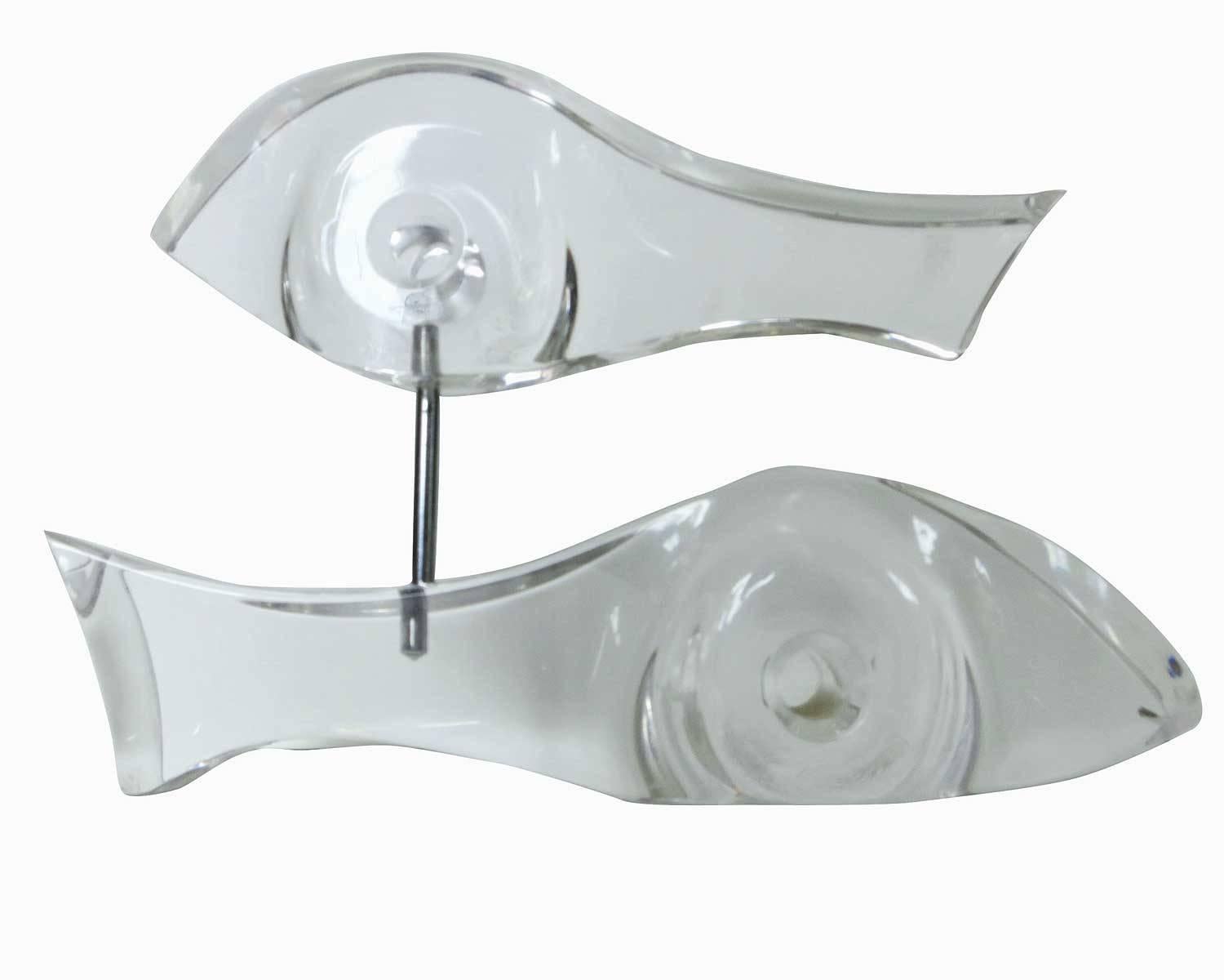 Abstract Lucite sculpture featuring two fish swing in the shape of a yinyang, circa 1960. There is one large 10” long sculpture serving as the base with second smaller 8.25
