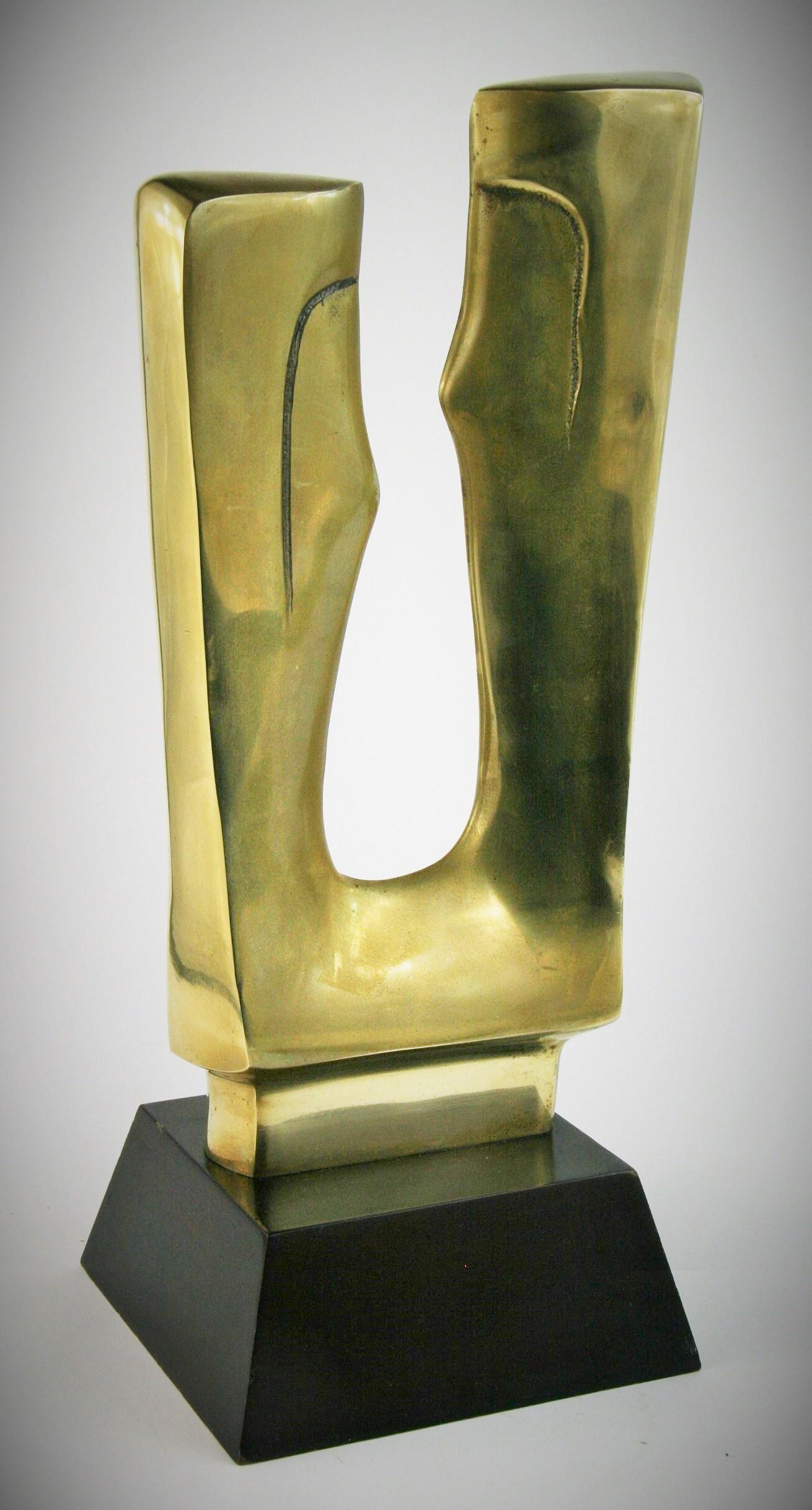 3-394 abstract brass sculpture on wood base.