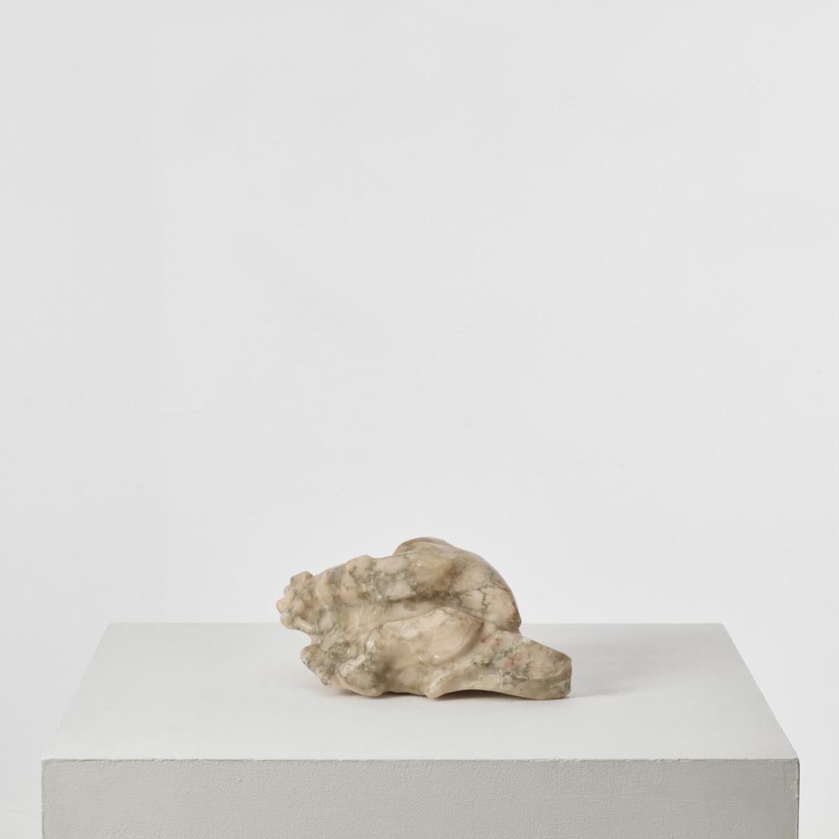 As much an artefact to handle and caress as a sculptural object, this marble piece retains the ruggedness of nature but combines it with artistic form. A skein of veins is revealed through the direct carving, and the shaping of the rock gives voice