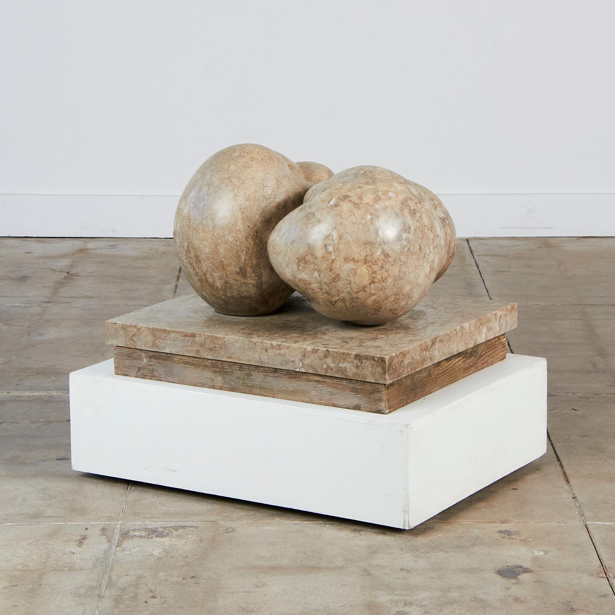 This sculpture from Amalia Schulthess is part of her Canto Series, c.1974, Los Angeles. The casting exhibits a fruit-breast style, displayed on a low platform, resembling giant spilled fruit. We can't help but see an heirloom tomato. 