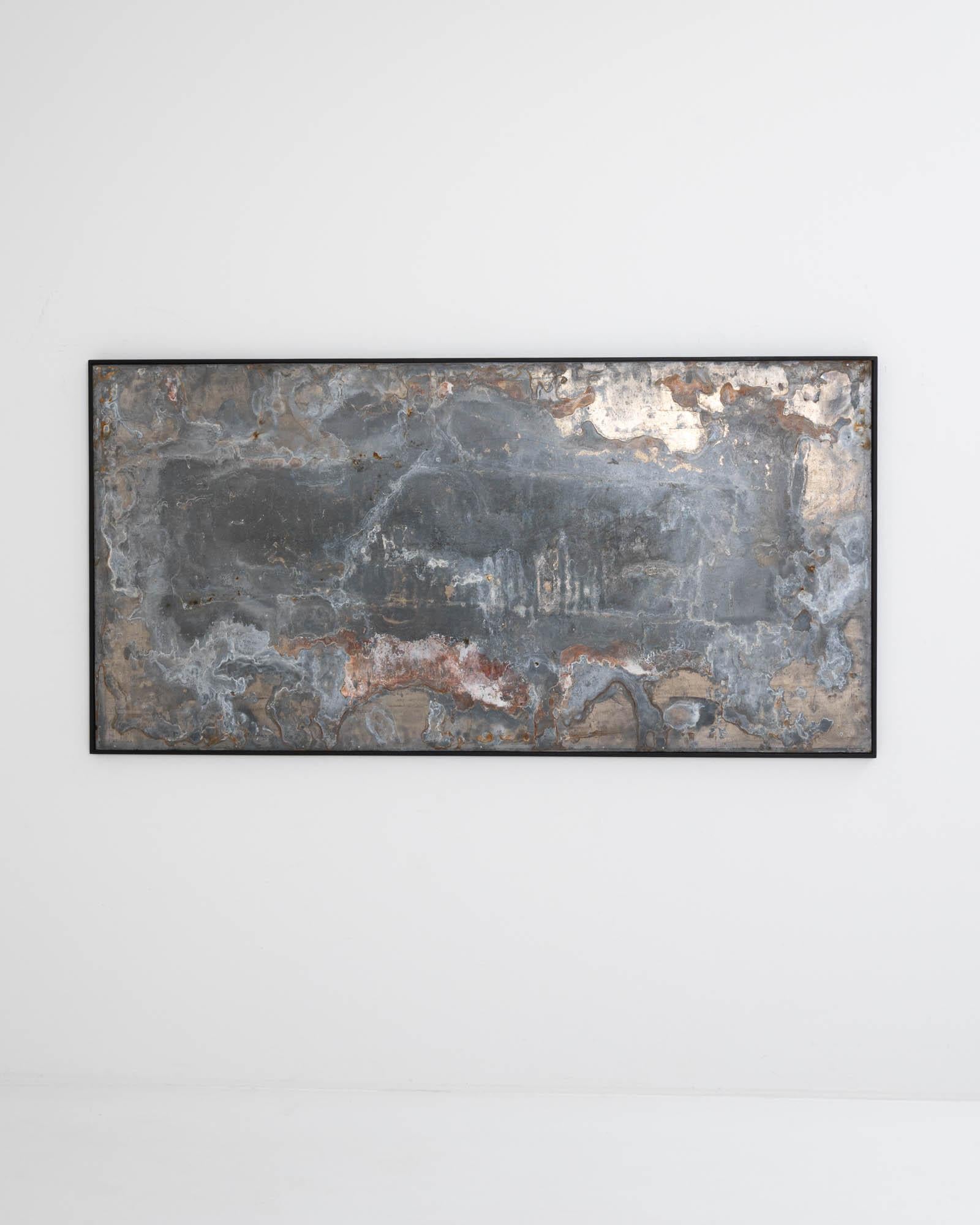 Bold and enigmatic, this large scale abstract artwork combines the hand of man and the hand of nature. The form has a Minimalist simplicity: a broad sheet of metal is set within a wooden frame. The surface of the metal combines human