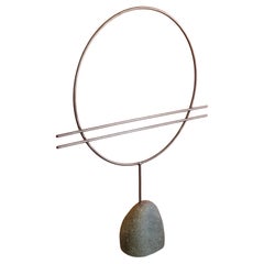 Abstract Metal Circle Sculpture on Stone Base