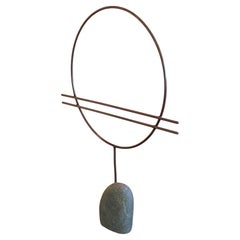 Abstract Metal Circle Sculpture on Stone Base