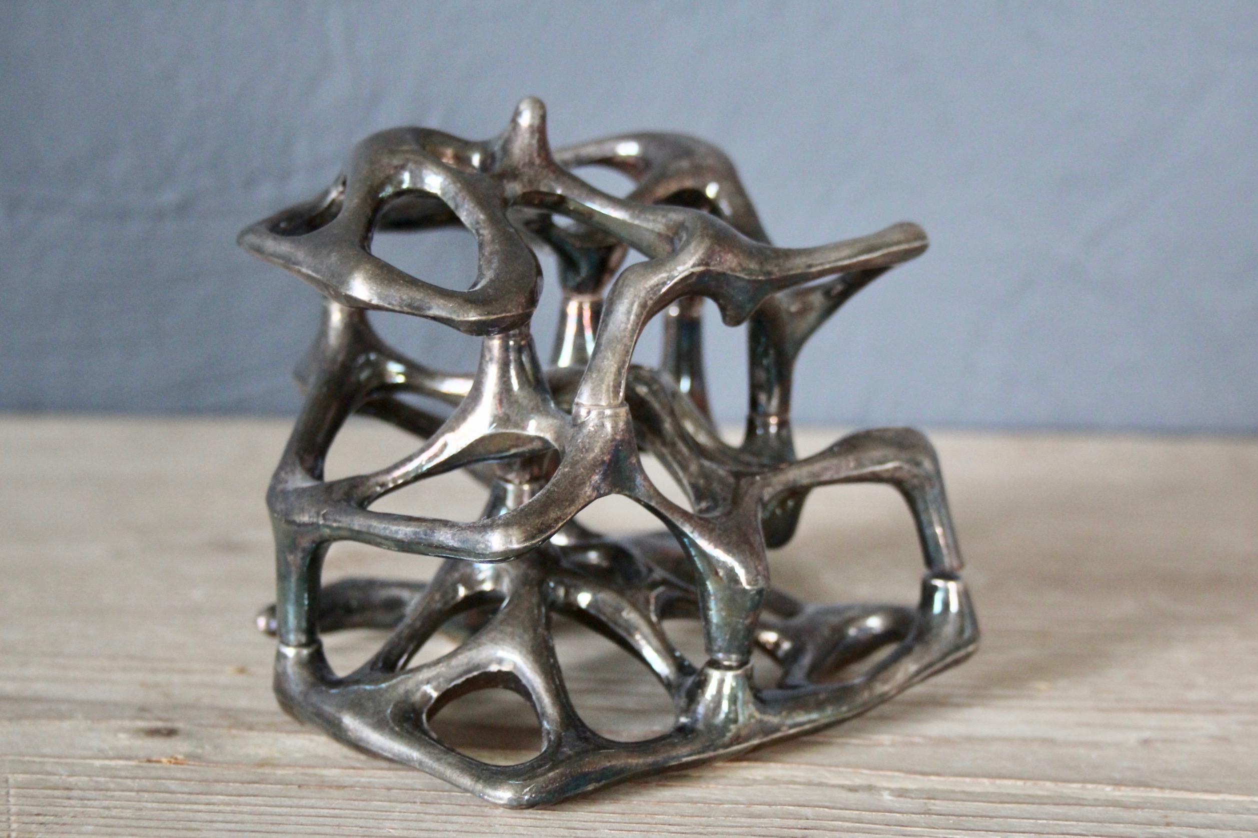 Small abstract metal sculpture signed Turbocalcin.