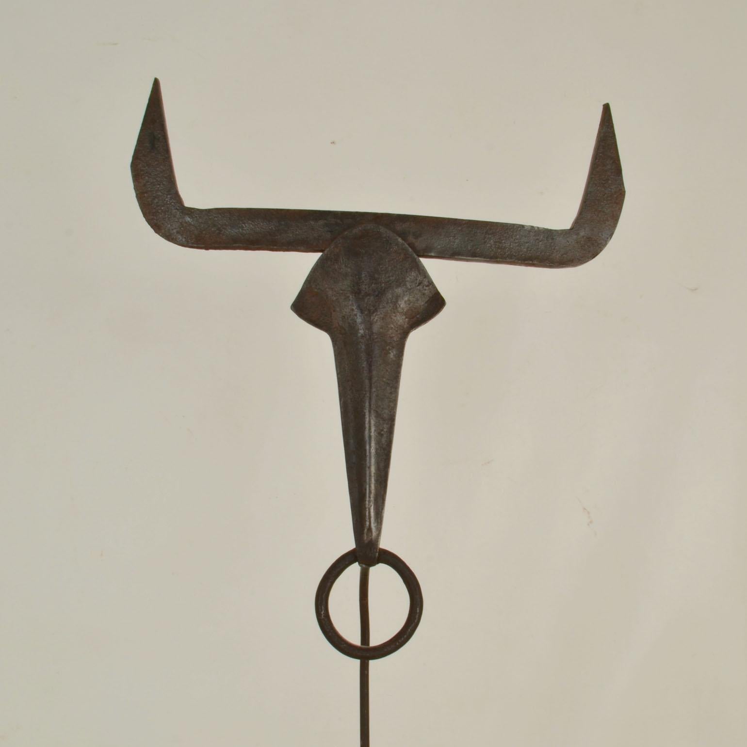 The forged metal sculpture of a bull's head in an abstract manner, circa 1970's. The bull is mostly known to be a symbol of stamina, stability, strength, tied to fertility, wealth, status, ancestry, and kinship, usually related, in its solar sense,